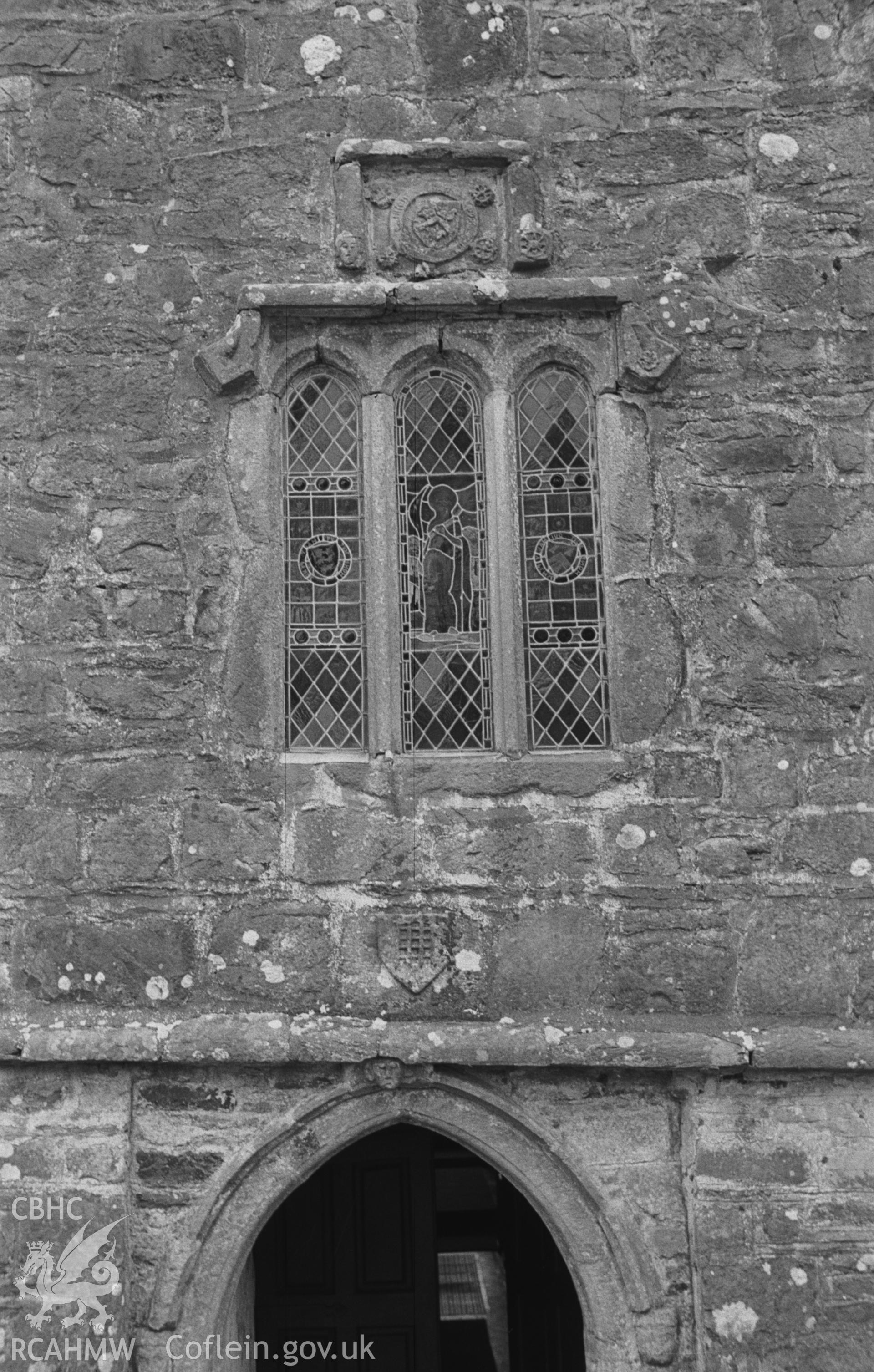 Digital copy of a black and white negative showing west door and window of St Gwenog's church, Llanwenog, at the base of the tower. Photographed in April 1963 by Arthur O. Chater from Grid Reference SN 4937 4552, looking east.