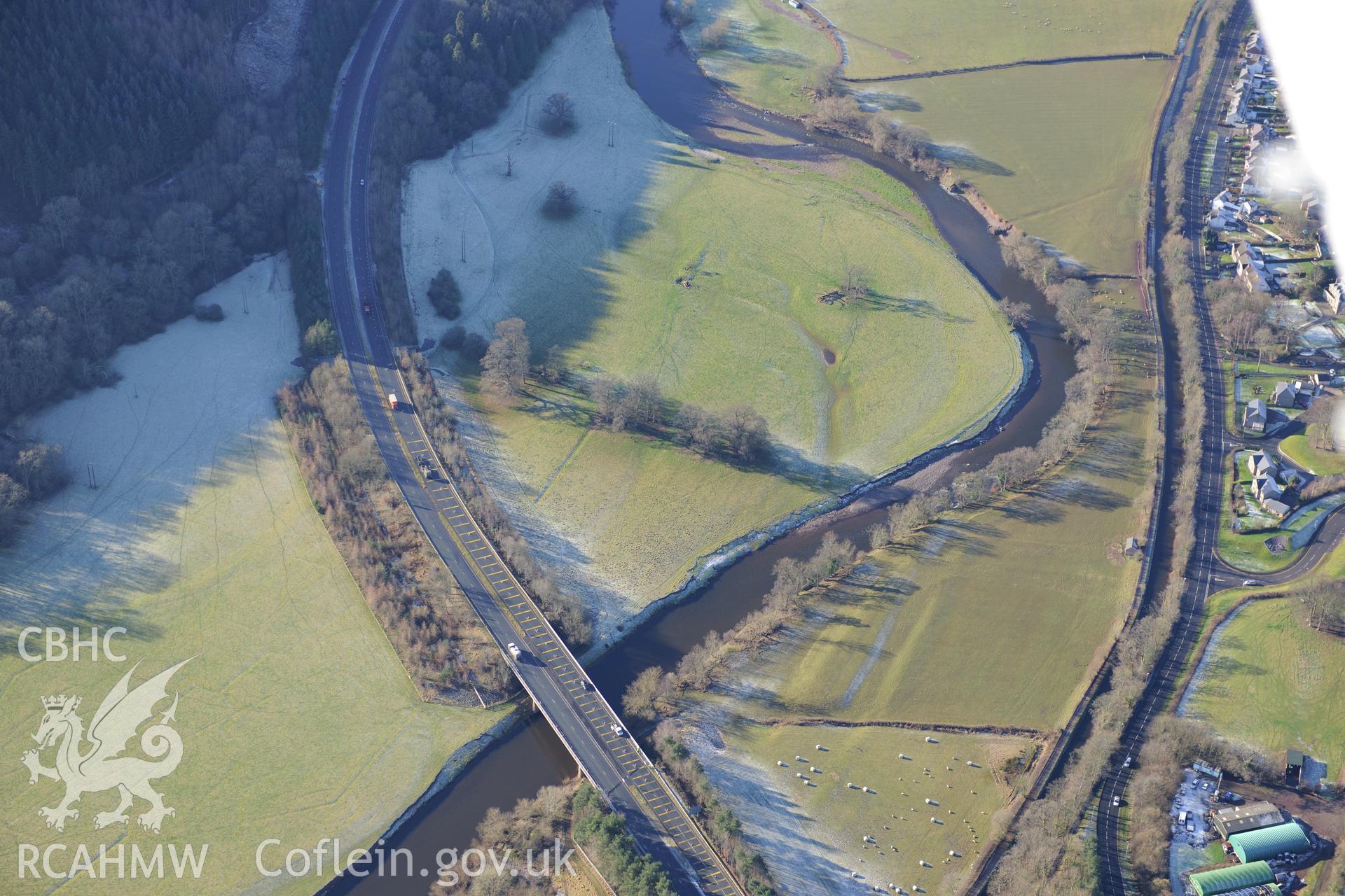 Water meadows north east of Closcoed and the bridge taking the A40 Brecon bypass over the river Usk, on the southern edge of Brecon. Oblique aerial photograph taken during the Royal Commission?s programme of archaeological aerial reconnaissance by Toby Driver on 15th June 2013.