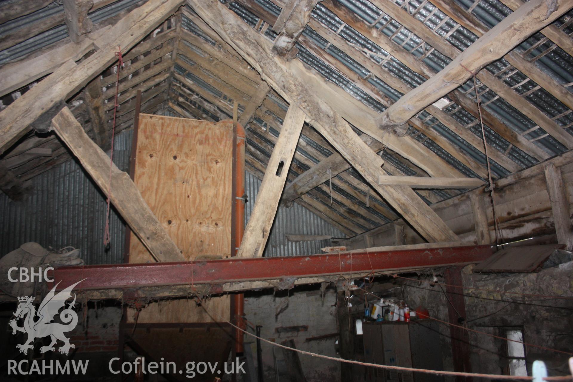 Interior view of barn or shed at Glanhafon-Fawr Farmstead showing timber frame with metal supports and a corrugated iron roof. Photographic survey of Glanhafon-Fawr Farmstead conducted by Geoff Ward on 4th November 2010.