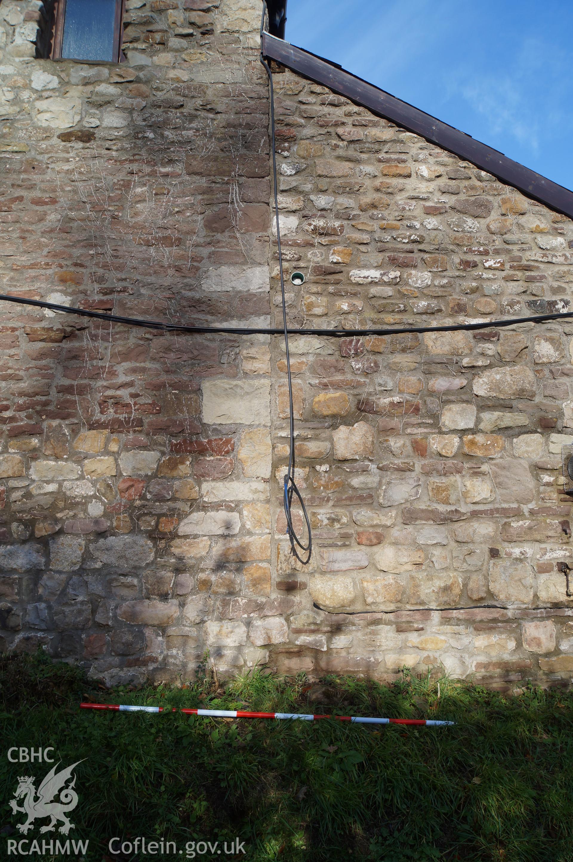 Detailed view looking north-northwest. 'The joint between the original barn and the late 19th century extension is seen here. Note the quoin stones of the barn.' Photographed and described by Jenny Hall and Paul Sambrook of Trysor, November 2018.