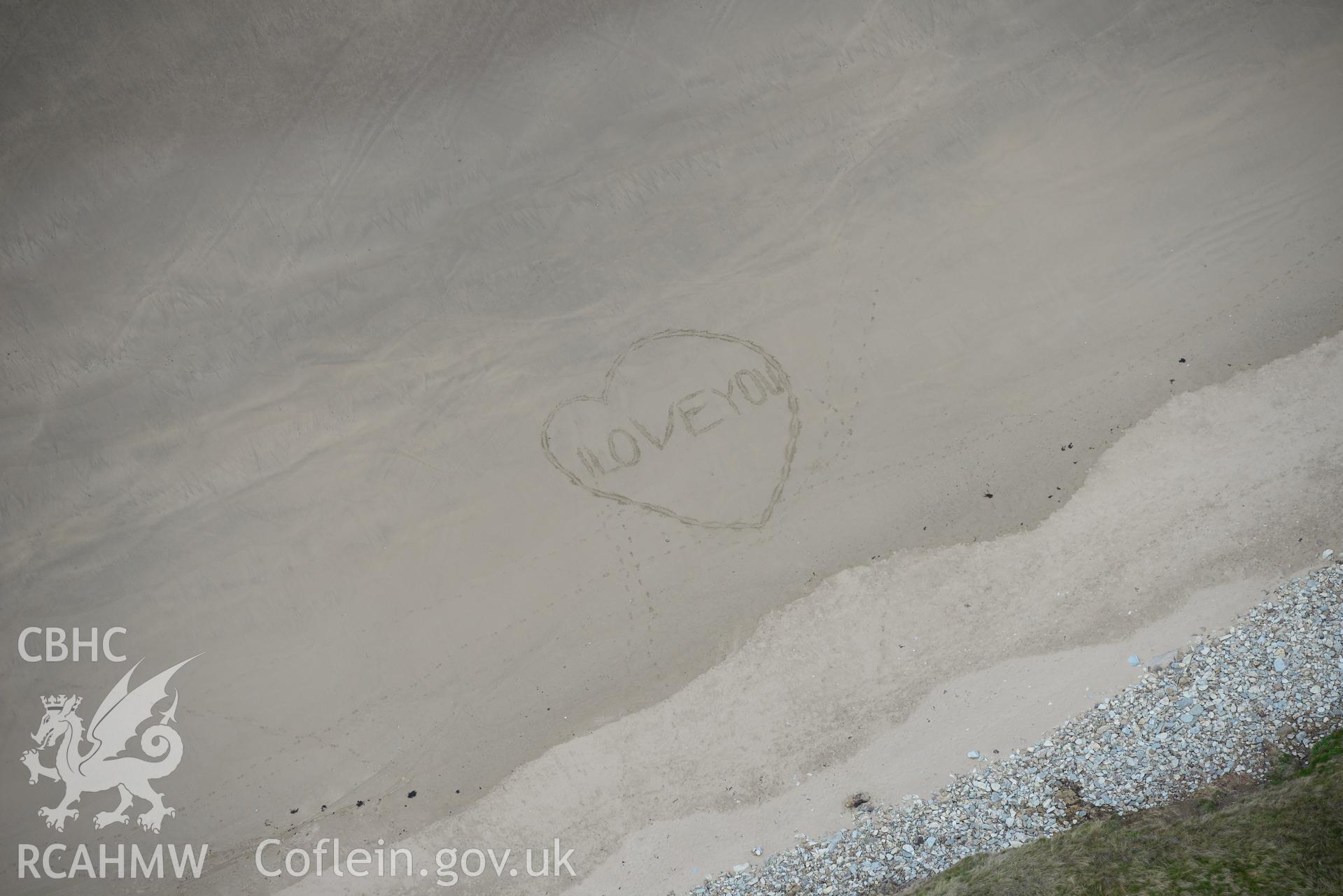 Writing in the sand at Whitesands Bay or Porth Mawr, near St. Davids. Oblique aerial photograph taken during the Royal Commission's programme of archaeological aerial reconnaissance by Toby Driver on 13th May 2015.