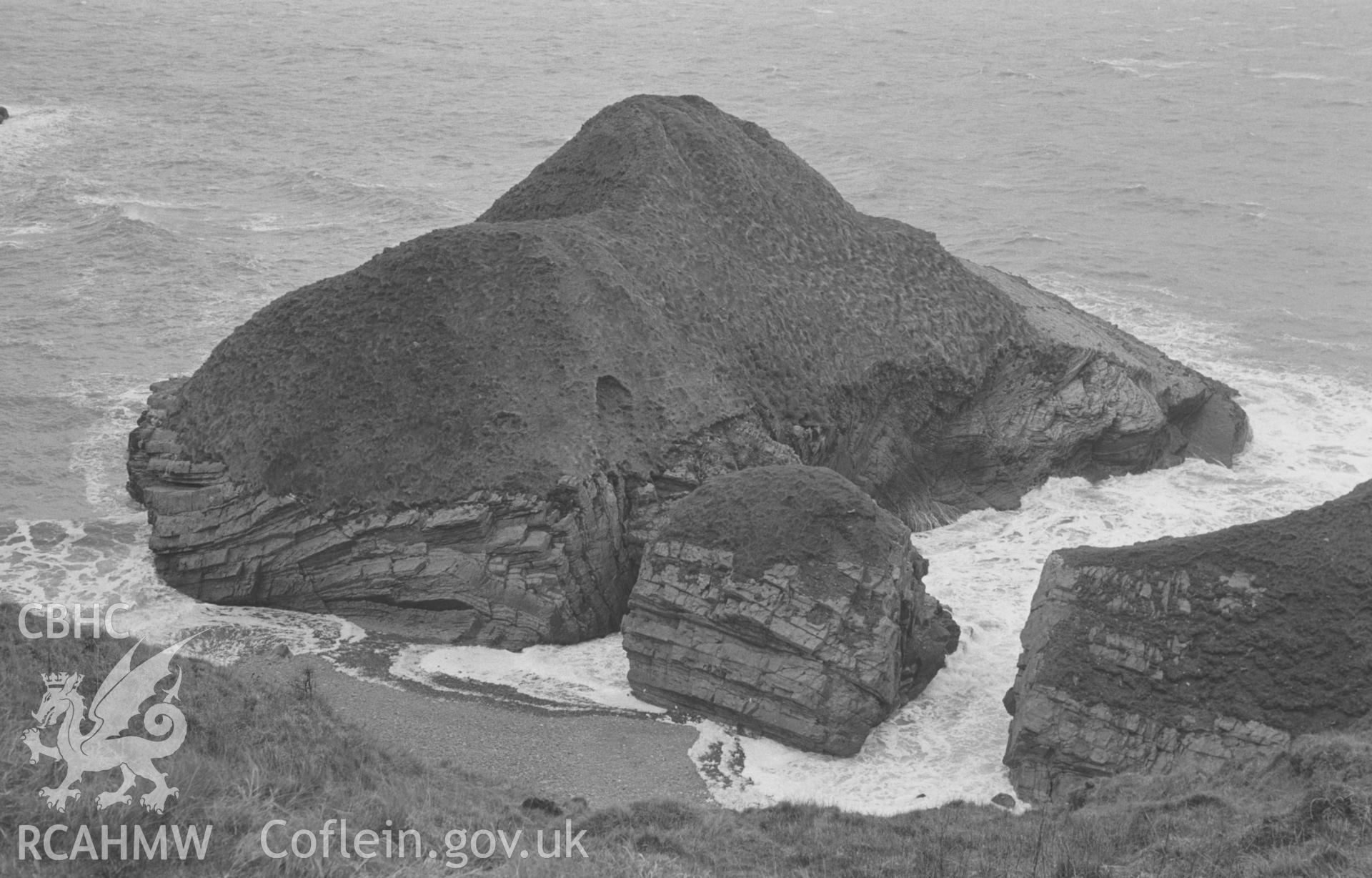 Digital copy of a black and white negative showing view looking down to the island (tide almost high) with Castell Bach out of sight on the right. Photographed by Arthur O. Chater in April 1966 from Grid Reference SN 360 579, looking north west.