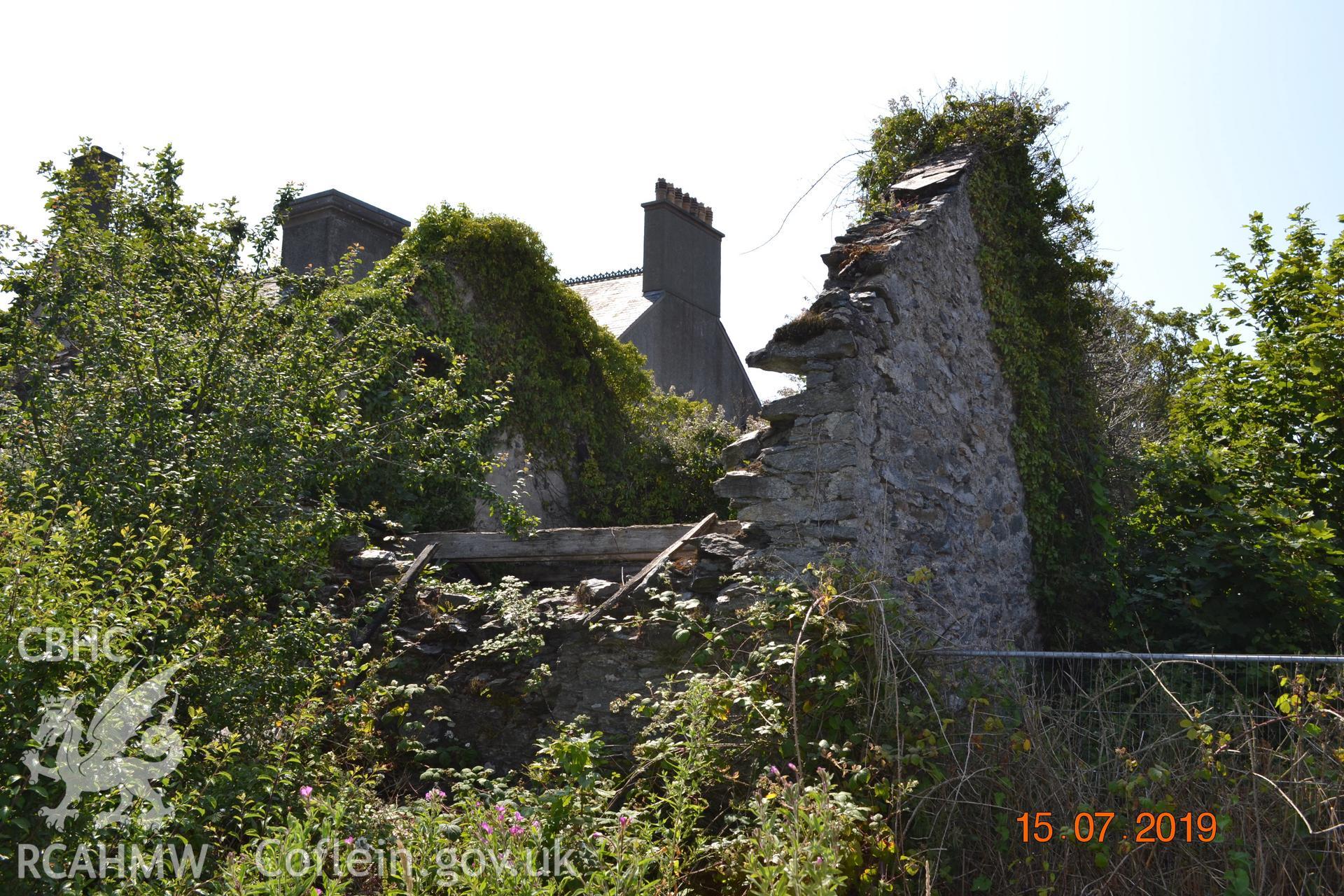Digital colour photograph showing north-western corner of the old garage at Fron Deg, Caergeiliog, Ynys Mon. Produced by Gerwyn Williams to meet a condition attached to a planning application, 2019.