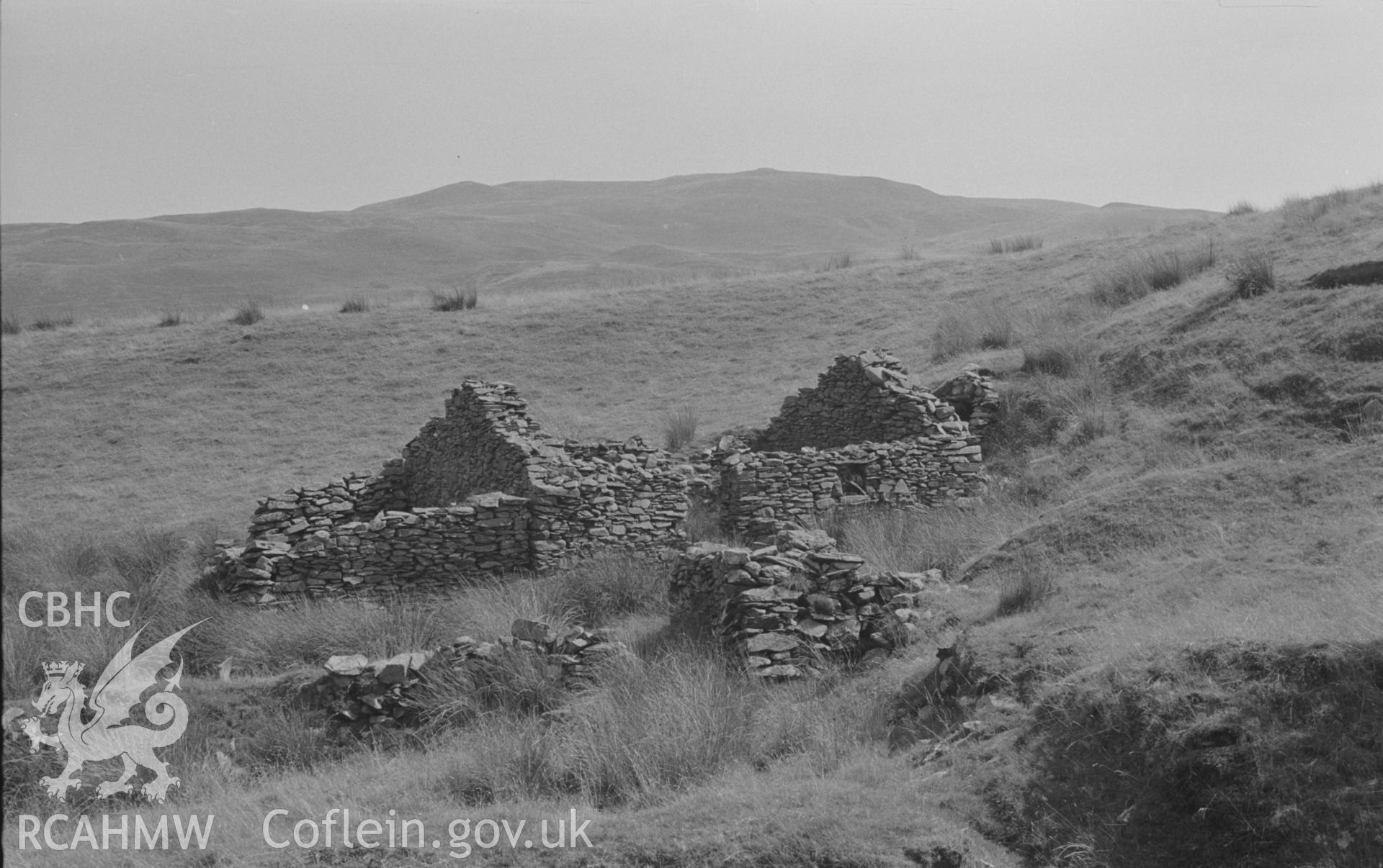 Digital copy of a black and white negative showing part of Ty-Canol ruin, halfway between Pen-Cwm and Ty-Newydd, at 1,000ft. Part of the Bryneithinog squatter settlement at Ystrad Fflur. Carn Fflur in distance. Photographed by Arthur O. Chater in August 1967. (Looking south east from Grid Reference SN 734 632).