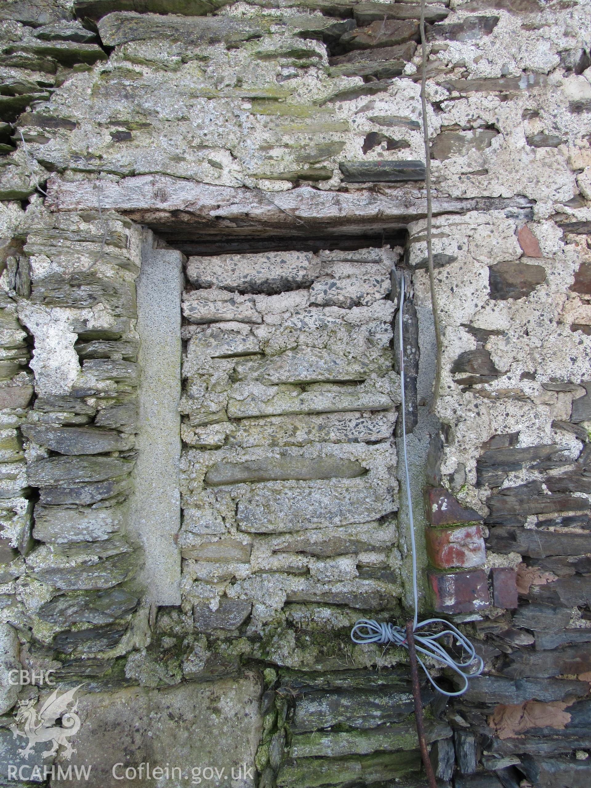 The barn north-west elevation blocked window, view south-east. 1m scale. Photographed as part of archaeological building recording conducted at Bryn Ysguboriau, Llanelidan, Denbighshire, carried out by Archaeology Wales, 2018. Project no. P2587.