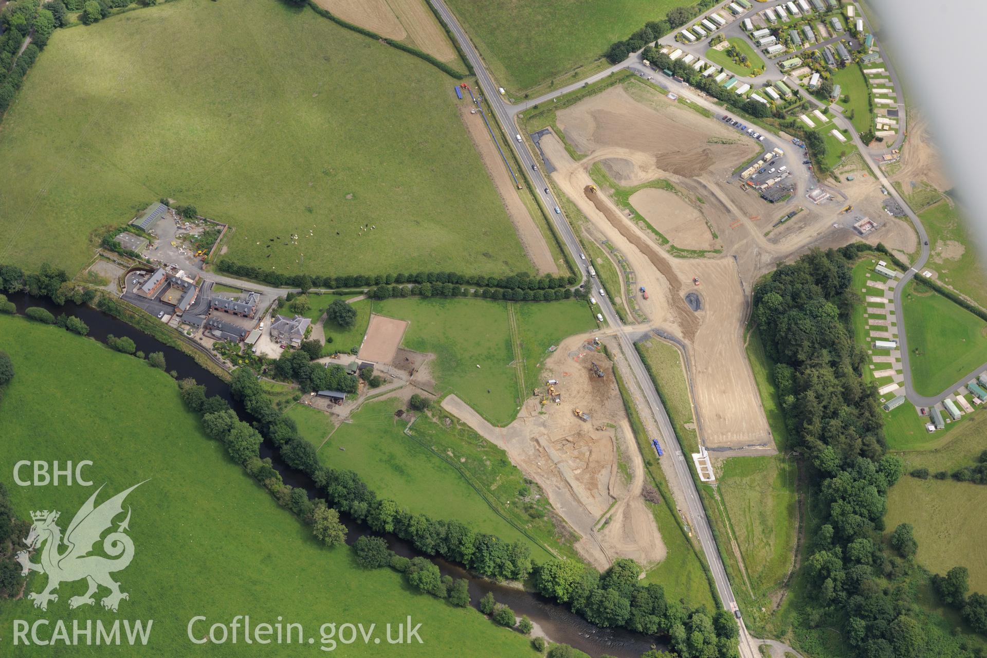 Royal Commission aerial reconnaissance of the construction of the Newtown Bypass. View near Glanhafren Hall (SO 083 902) with excavation of Roman road in progress