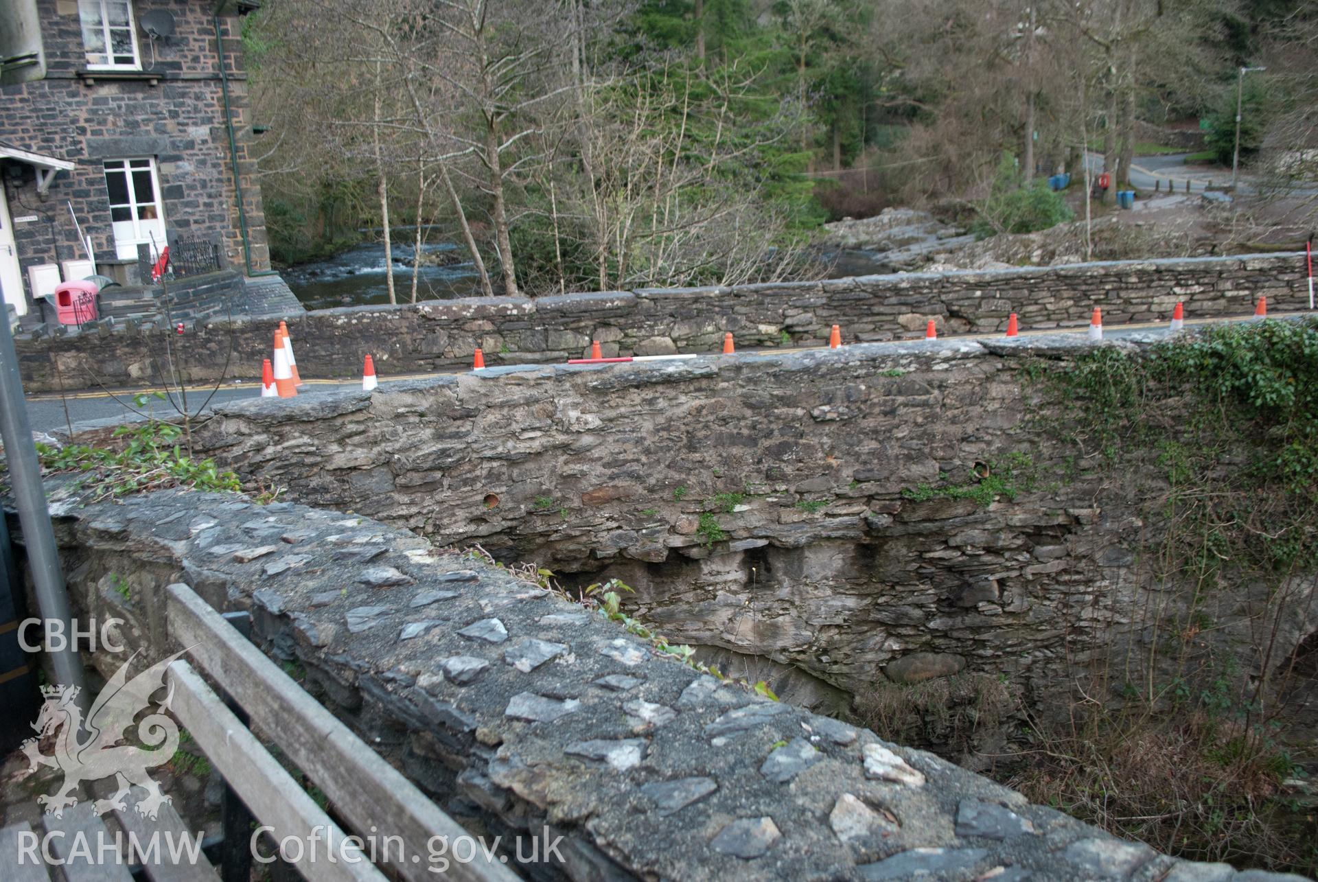 View from the east south east of external (riverside) of parapet walling in the southeast corner of the bridge. Digital photograph taken for Archaeological Watching Brief at Pont y Pair, Betws y Coed, 2019. Gwynedd Archaeological Trust Project ref G2587.