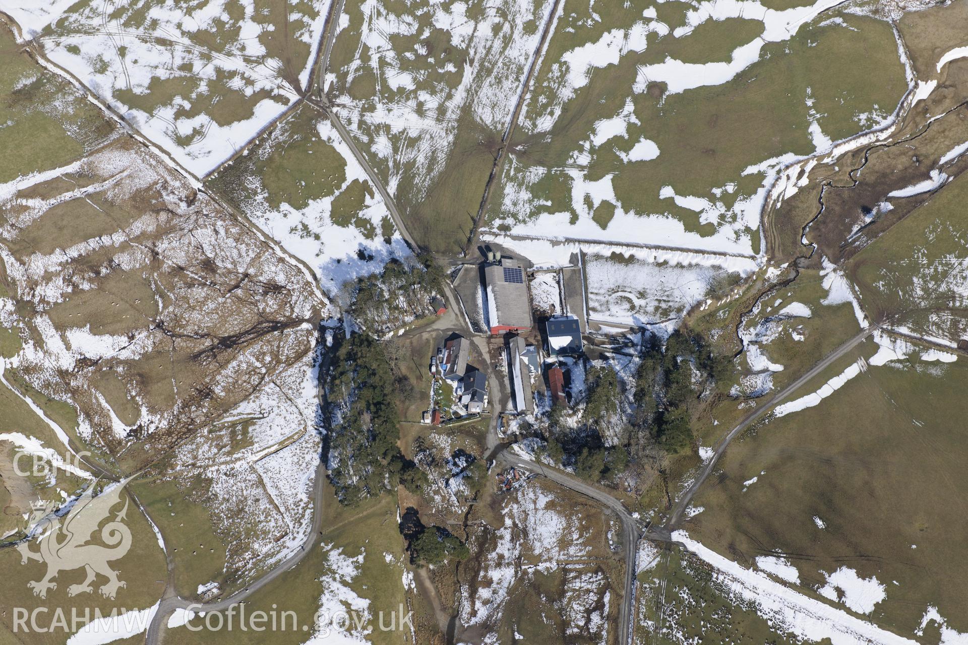 Nant-yr-Hafod farm, with a possibly decorative circular garden enclosure revealed by the light dusting of snow. Oblique aerial photograph taken during the Royal Commission?s programme of archaeological aerial reconnaissance by Toby Driver on 2nd April 2013.