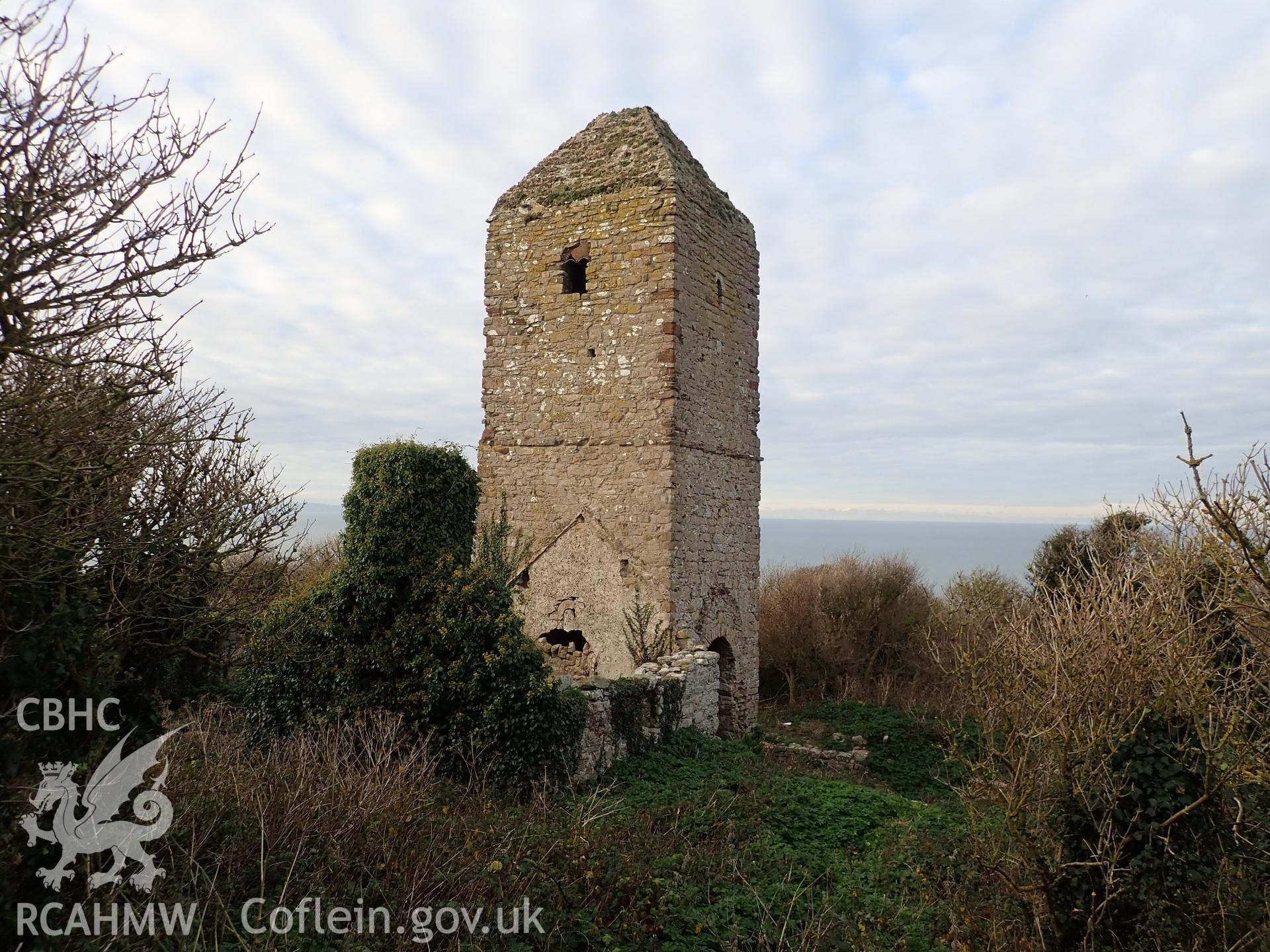 Investigator's photographic survey of the church on Puffin Island or Ynys Seiriol for the CHERISH Project. Winter view of church tower from south-east, showing overgrown environs. ? Crown: CHERISH PROJECT 2018. Produced with EU funds through the Ireland Wales Co-operation Programme 2014-2020. All material made freely available through the Open Government Licence.