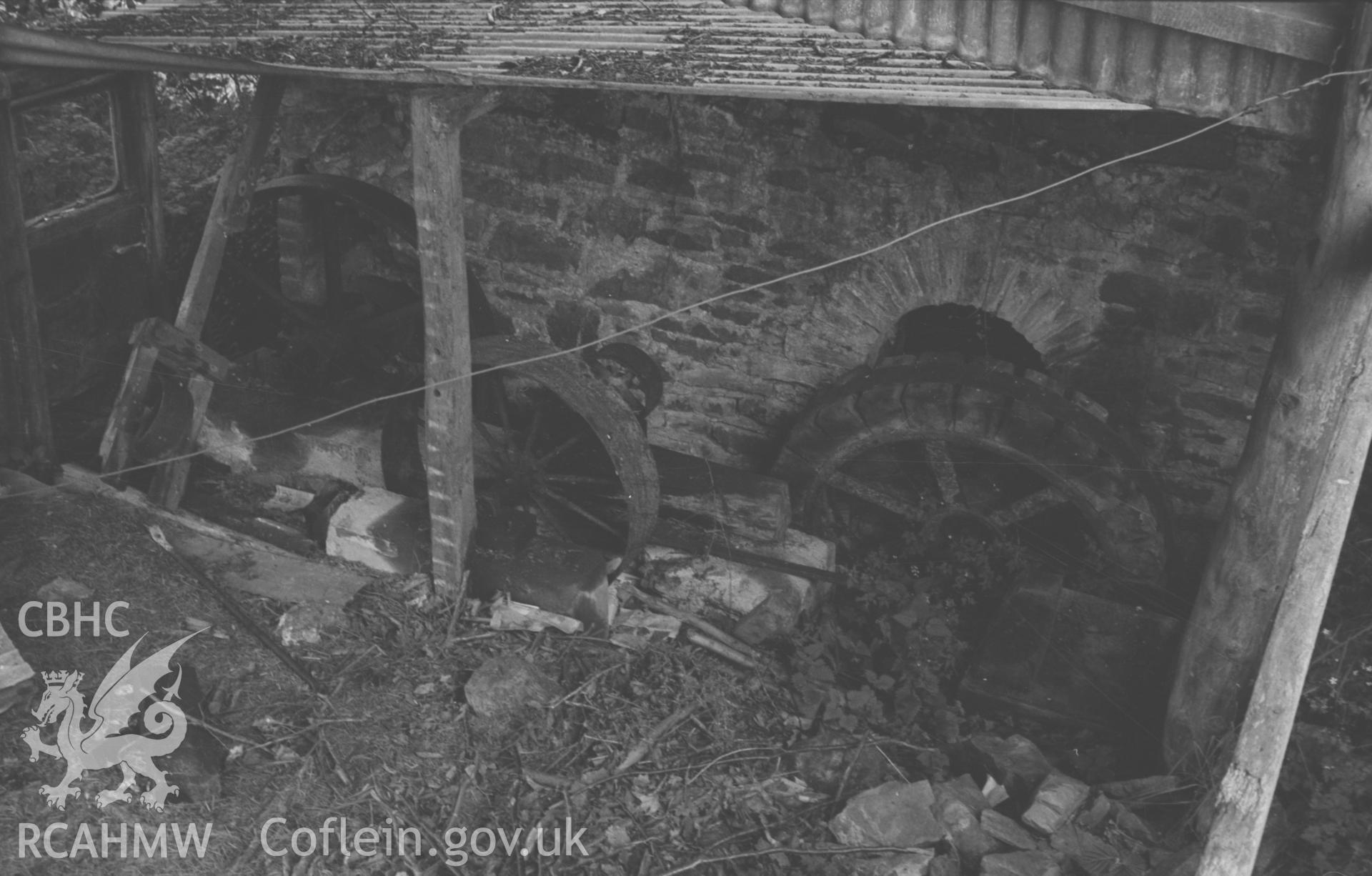Digital copy of a black and white negative showing machinery in the old mill building at Melin Cwm-Hyar on the Cerdin, 2.5km south east of FFostrasol. Photographed by Arthur O. Chater on 19th August 1967 looking east from Grid Reference SN 391 459.