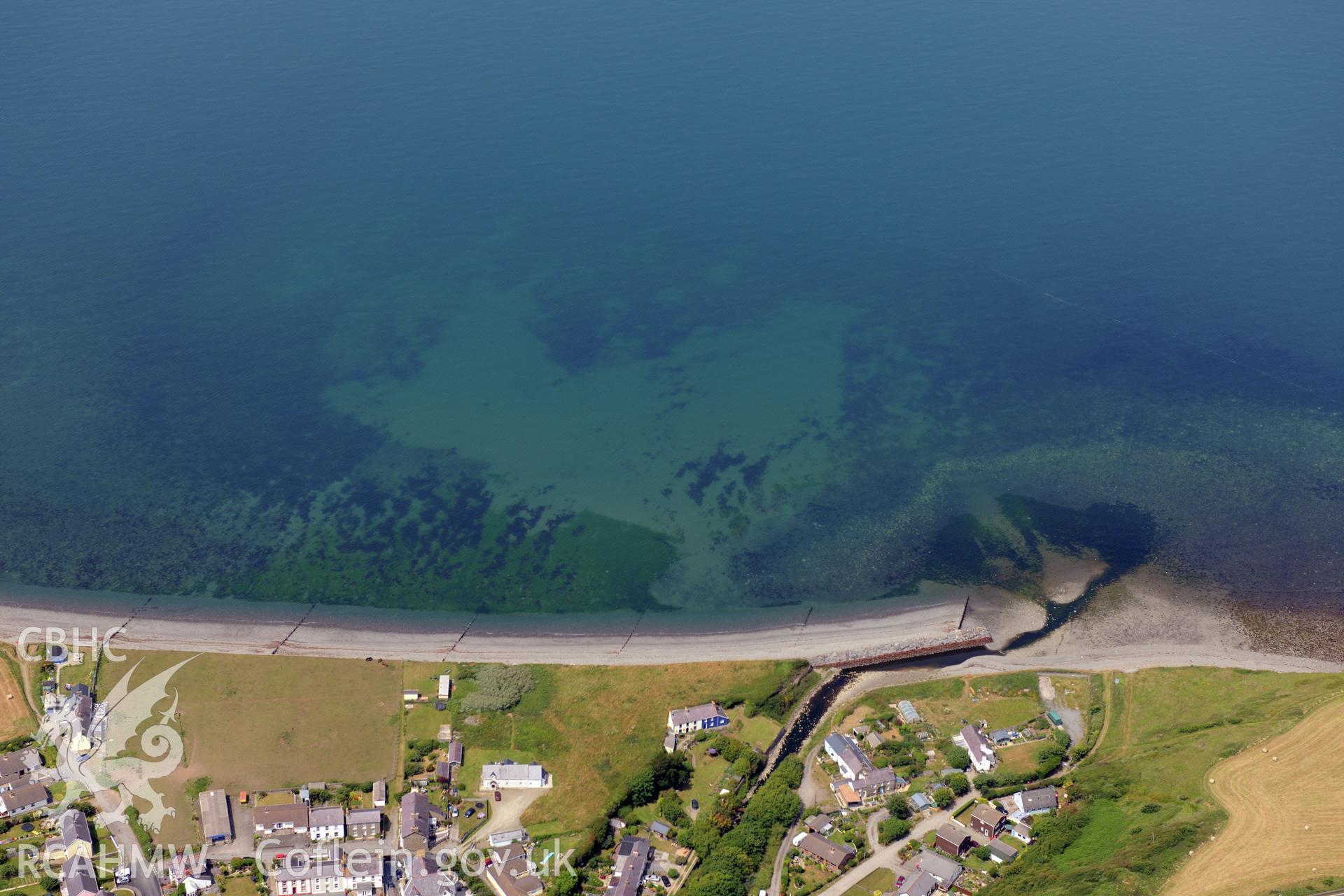 Aberarth village with Aberarth fish trap complex just off the shore. Oblique aerial photograph taken during the Royal Commission?s programme of archaeological aerial reconnaissance by Toby Driver on 12th July 2013.