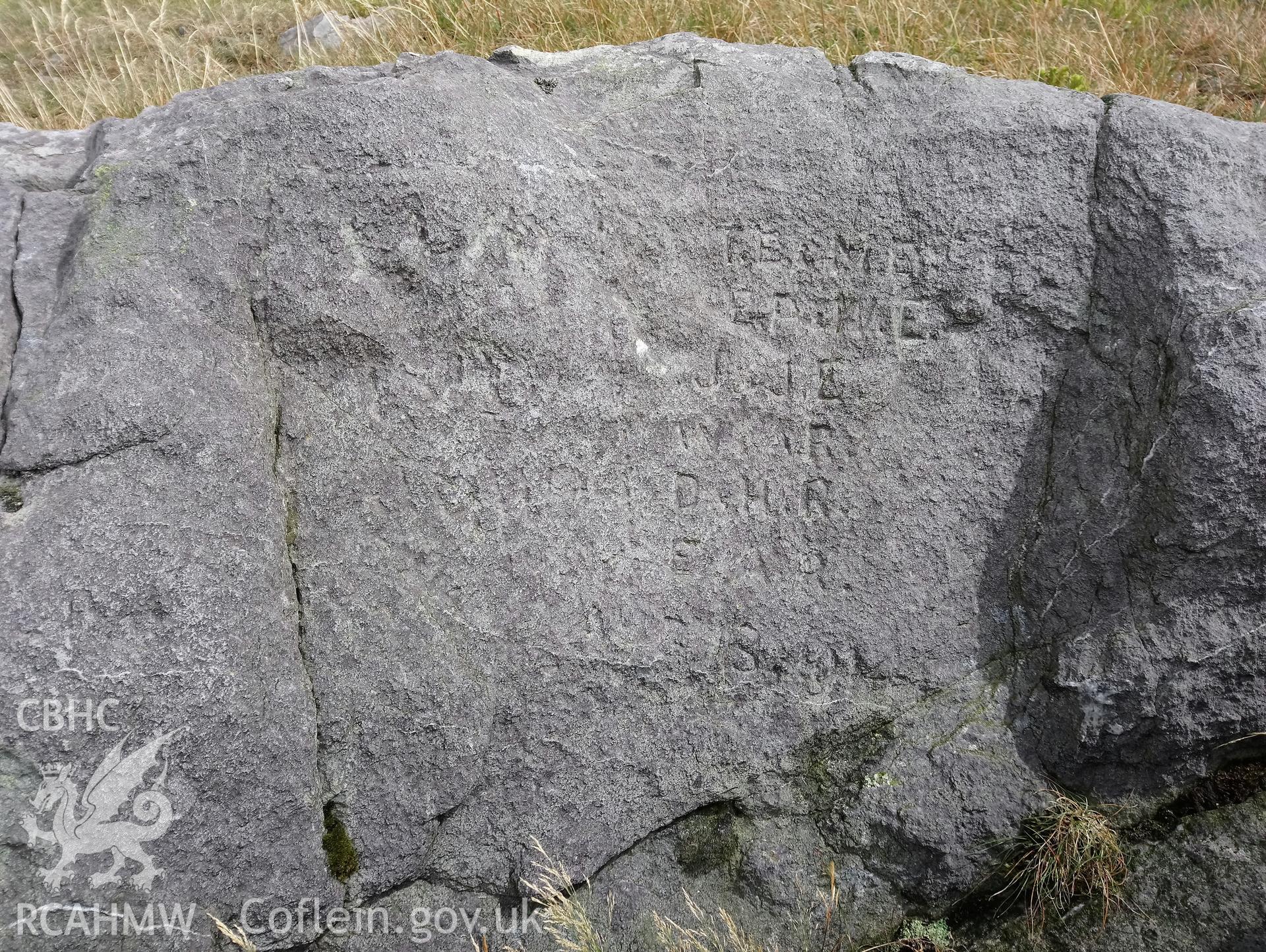 Investigator's photography of an inscribed stone on the summit of Plynlimon