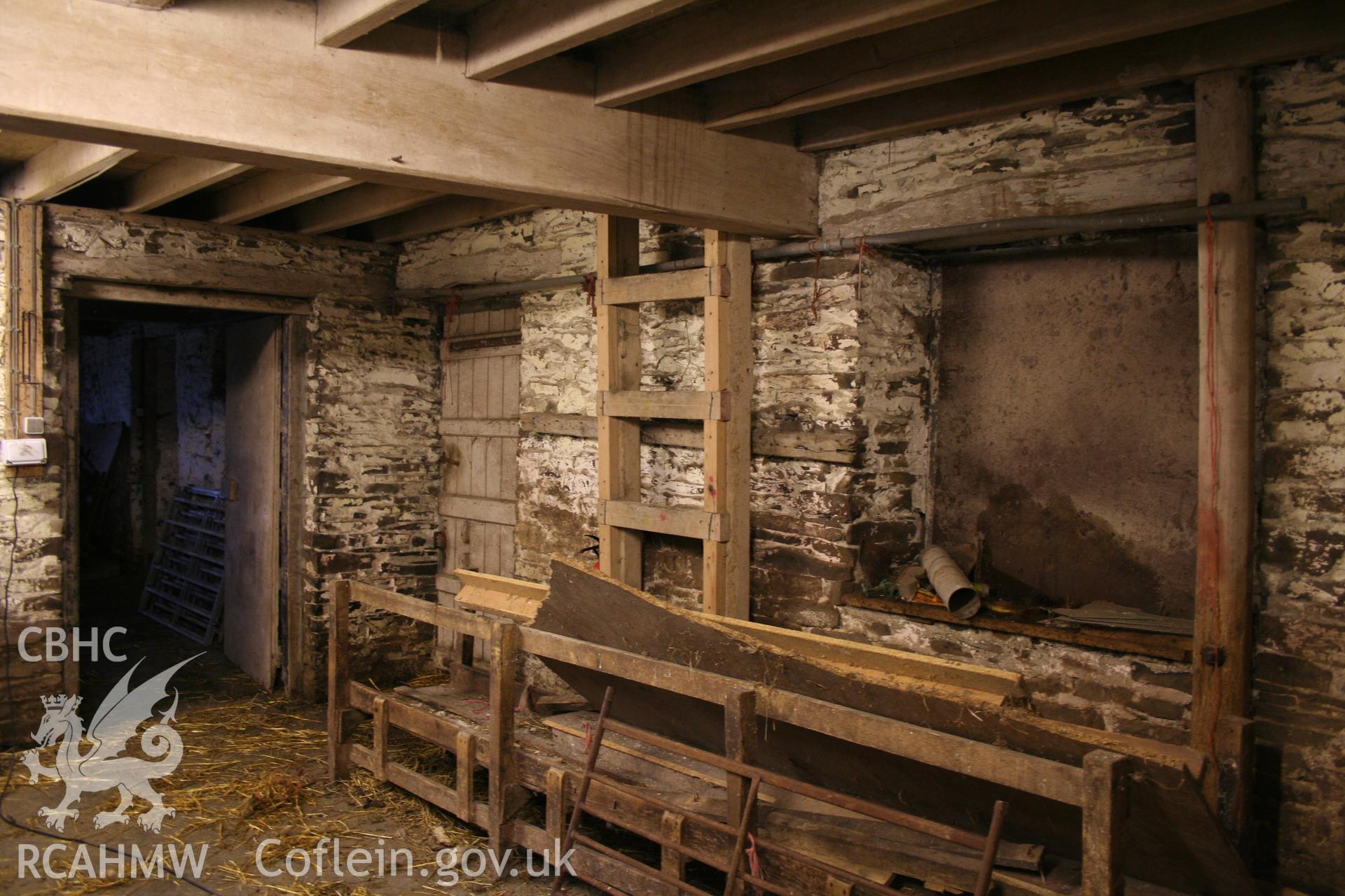 Interior view showing stone walls, wooden beams and wooden doors. Photographic survey of the threshing house, straw house, mixing house and root house at Tan-y-Graig Farm, Llanfarian, conducted by Geoff Ward and John Wiles, 11th December 2006.