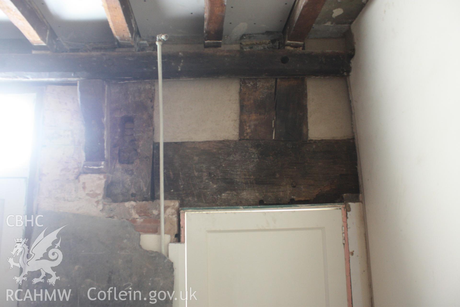 Colour photograph showing detail of timber frame above door at Porth-y-Dwr, 67 Clwyd Street, Ruthin. Photographed during survey conducted by Geoff Ward on 10th June 2013.