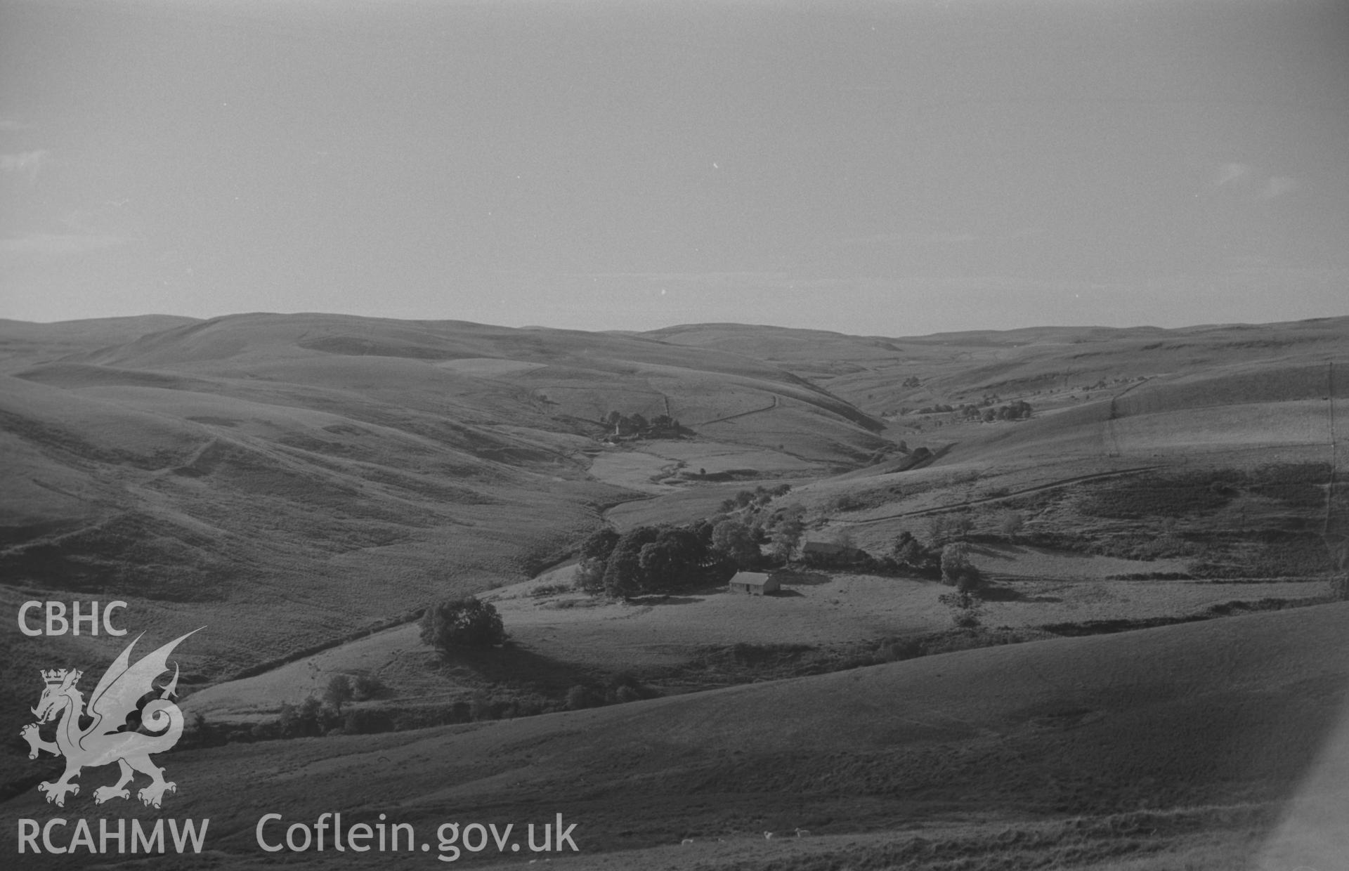 Digital copy of black & white negative looking up Pysgotwr Fawr valley; Bryn-Ambor farm and lead mine in middle distance; Bryn-Glas and Nant Gwerrog in the distance. Photograph by Arthur O. Chater, September 1966, looking north west from SN 750 505.