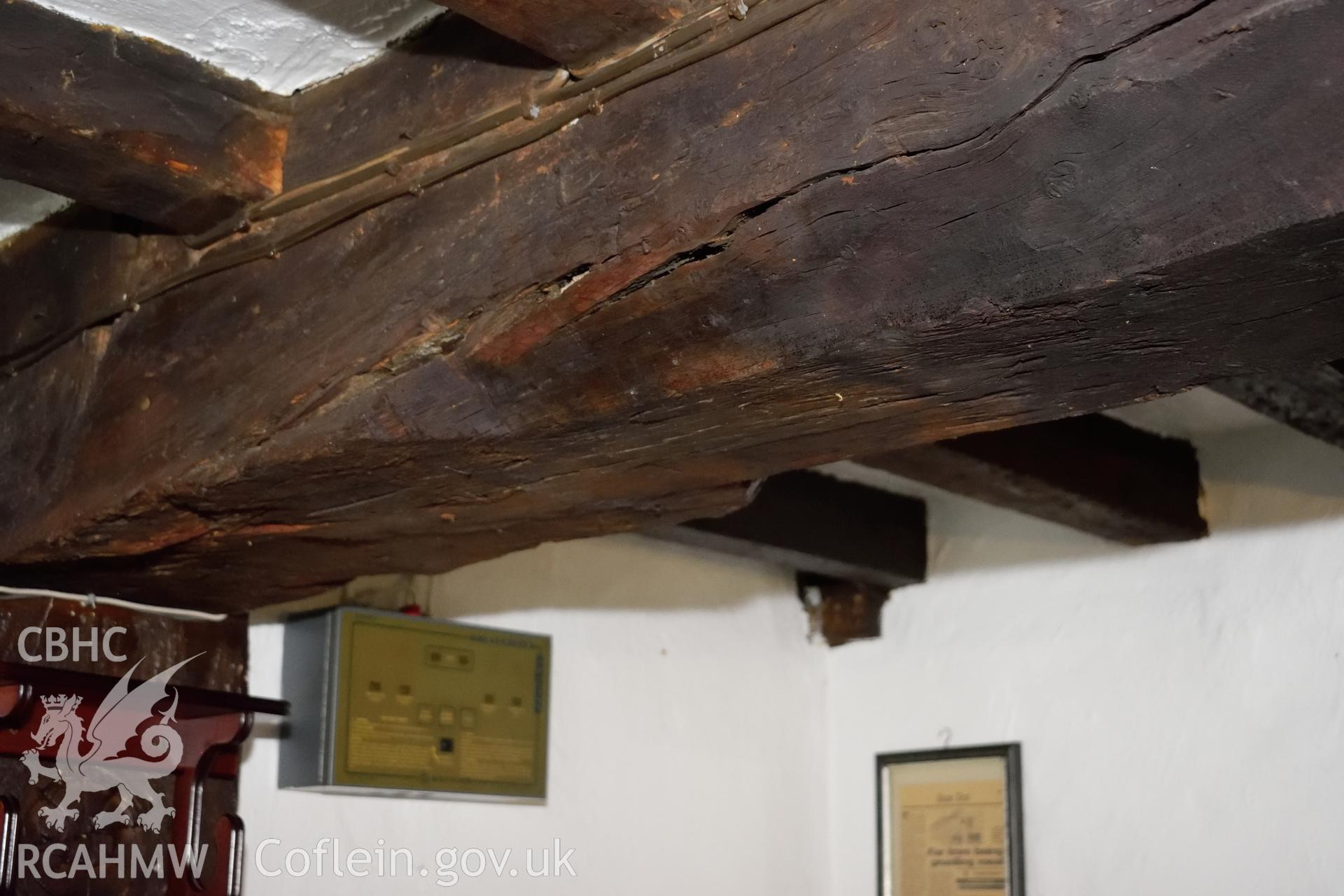 Colour photograph showing view looking south at chamfer and stop on the eastern ceiling beam at Y Sospan, Llys Owain, Dolgellau. Photographed by I. P. Brookes of Engineering Archaeological Services, June 2019.