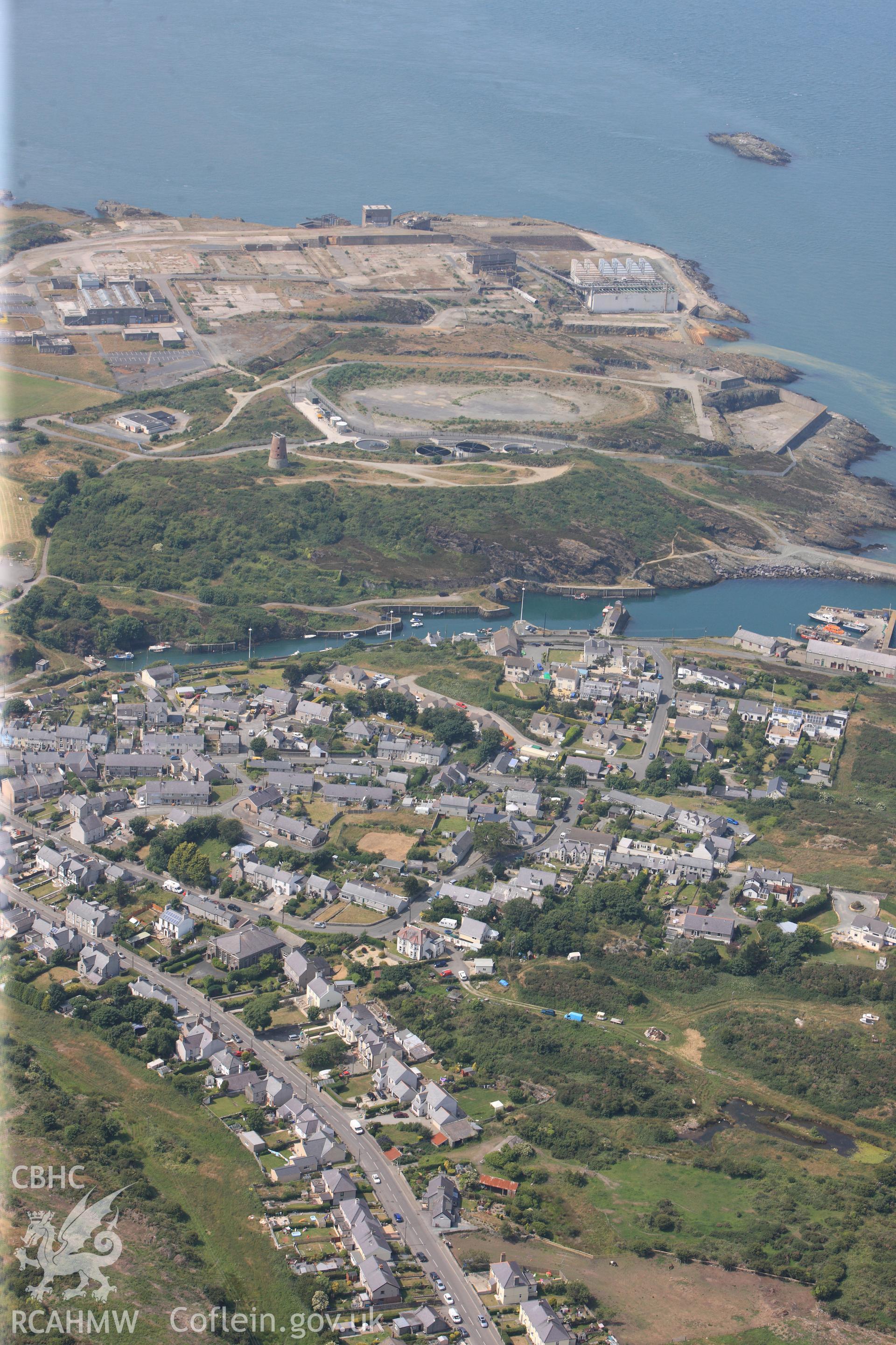 Bromine Works, Amlwch Harbour and the village of Amlwch, Anglesey. Oblique aerial photograph taken during the Royal Commission?s programme of archaeological aerial reconnaissance by Toby Driver on 12th July 2013.