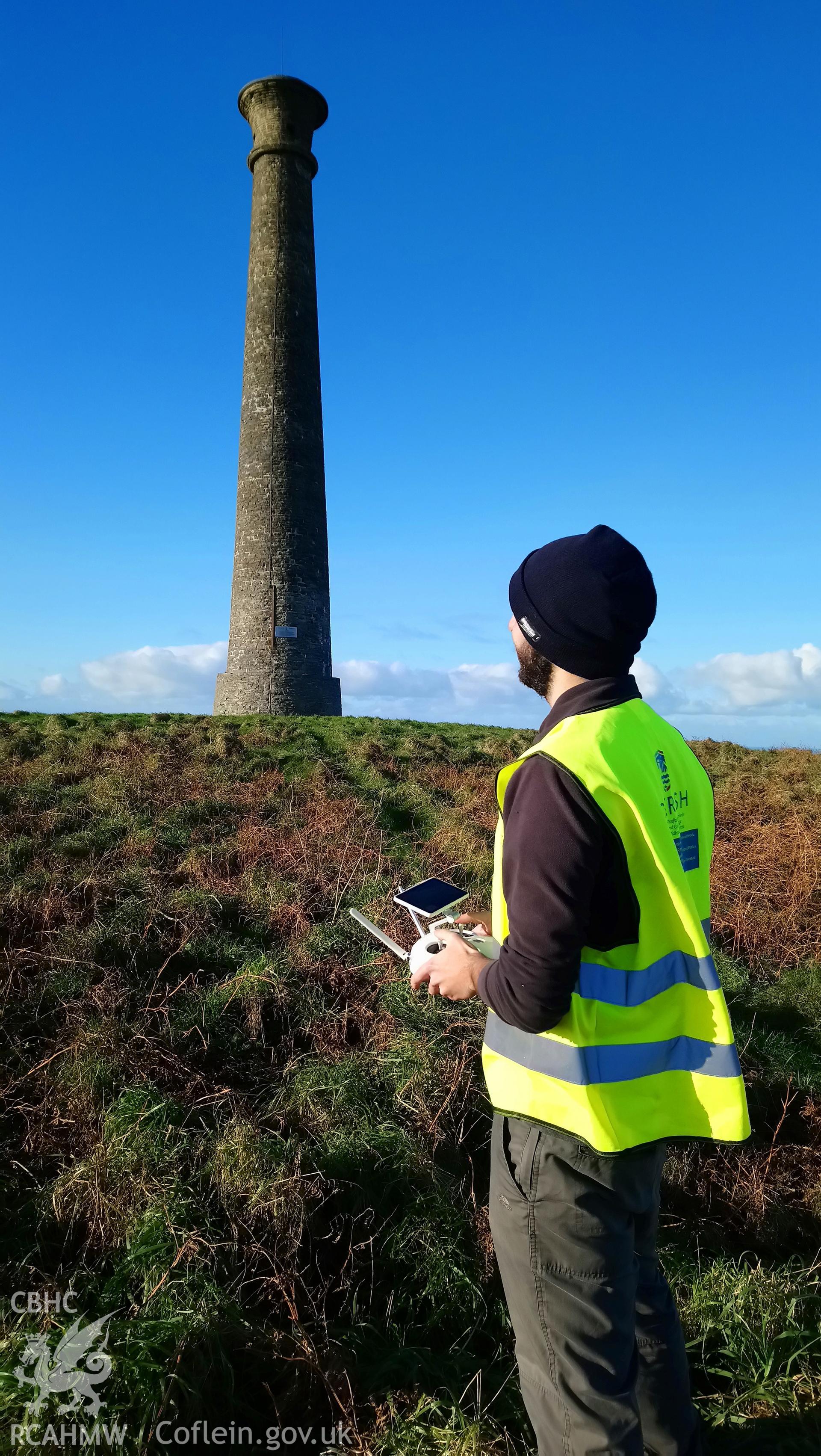 Dan Hunt flying the drone on Pen Dinas. CHERISH Project DJI drone photo survey of Pen Dinas Hillfort and the Wellington Monument. ? Crown: CHERISH PROJECT 2017. Produced with EU funds through the Ireland Wales Co-operation Programme 2014-2020. All material made freely available through the Open Government Licence.