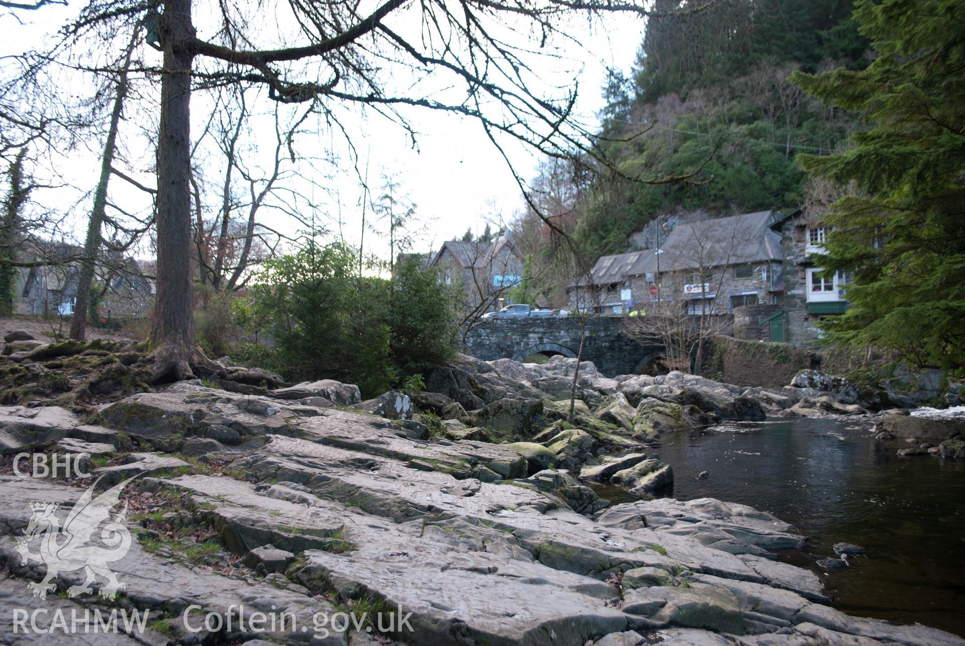 General view from the west of Pont y Pair bridge from the riverbank and waterfall. Digital photograph taken for Archaeological Watching Brief at Pont y Pair, Betws y Coed, 2019. Gwynedd Archaeological Trust Project no. G2587.