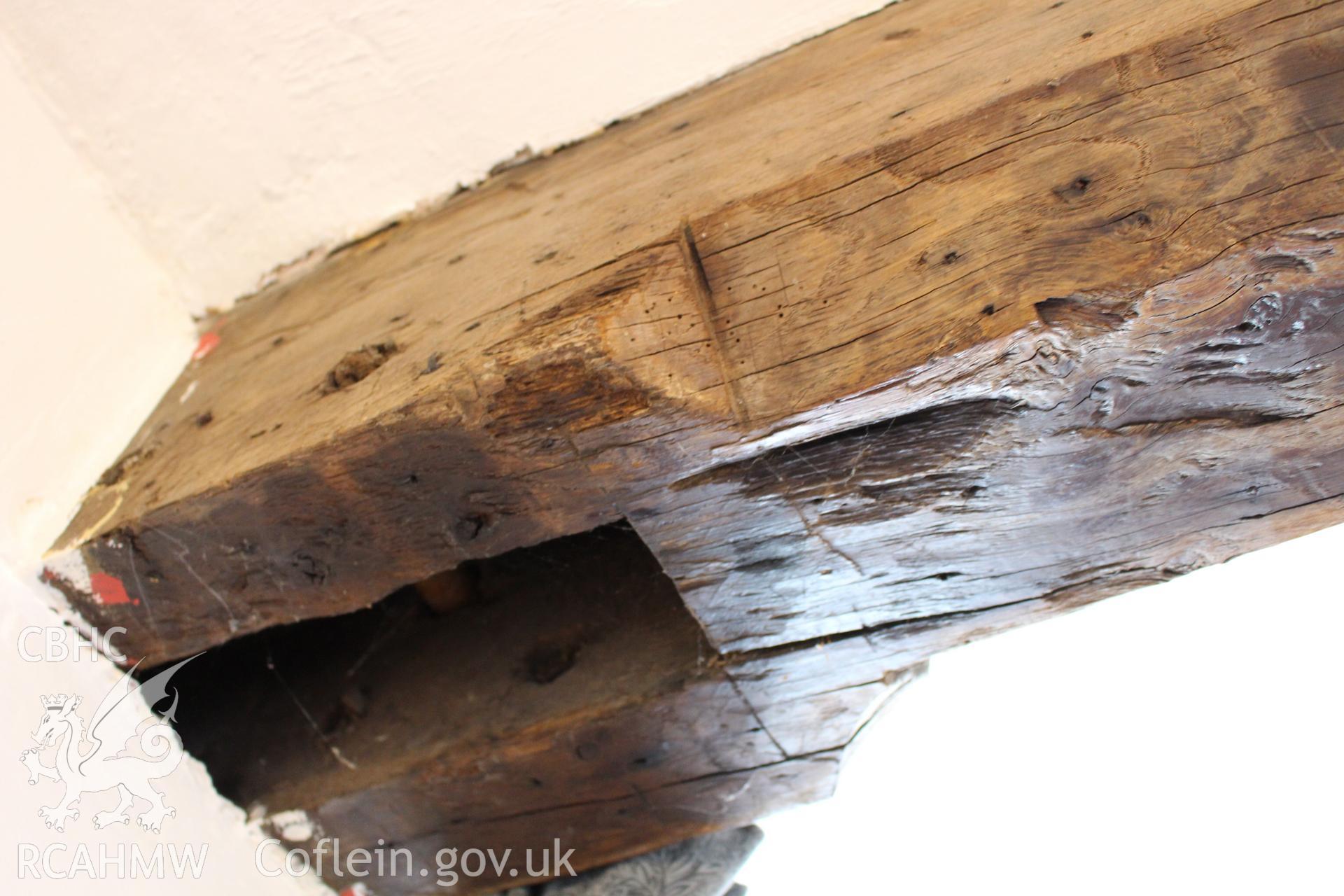 Colour photograph showing detail of wooden beam at 5-7 Mwrog Street, Ruthin. Photographed during survey conducted by Geoff Ward on 14th May 2014.