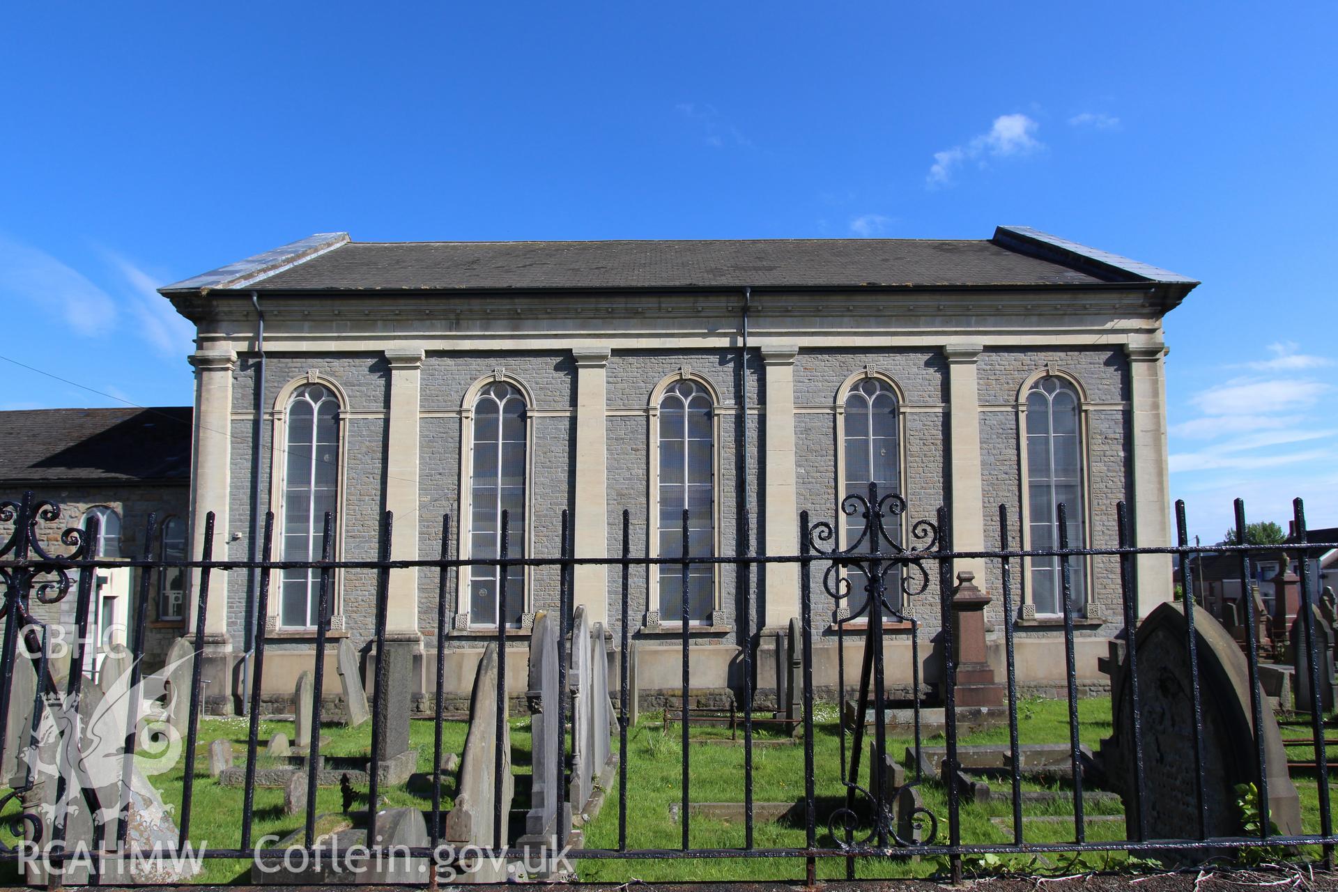Exterior view of chapel with graveyard and iron fence in foreground. Photographic survey of Seion Welsh Baptist Chapel, Morriston, conducted by Sue Fielding on 13th May 2017.