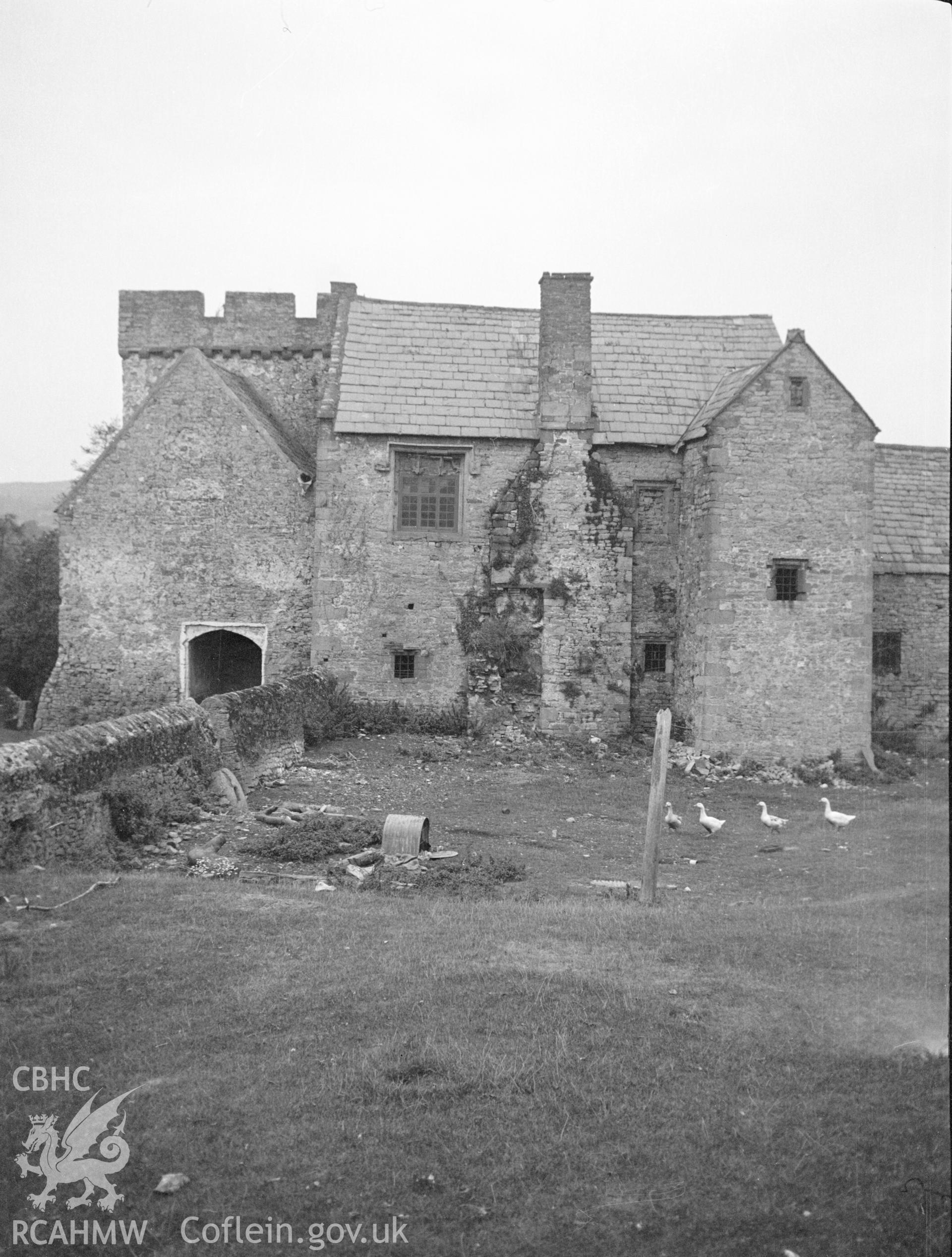 Digital copy of a nitrate negative showing exterior view of Penhow Castle - used as a farmhouse and farm buildings. From the National Building Record Postcard Collection.