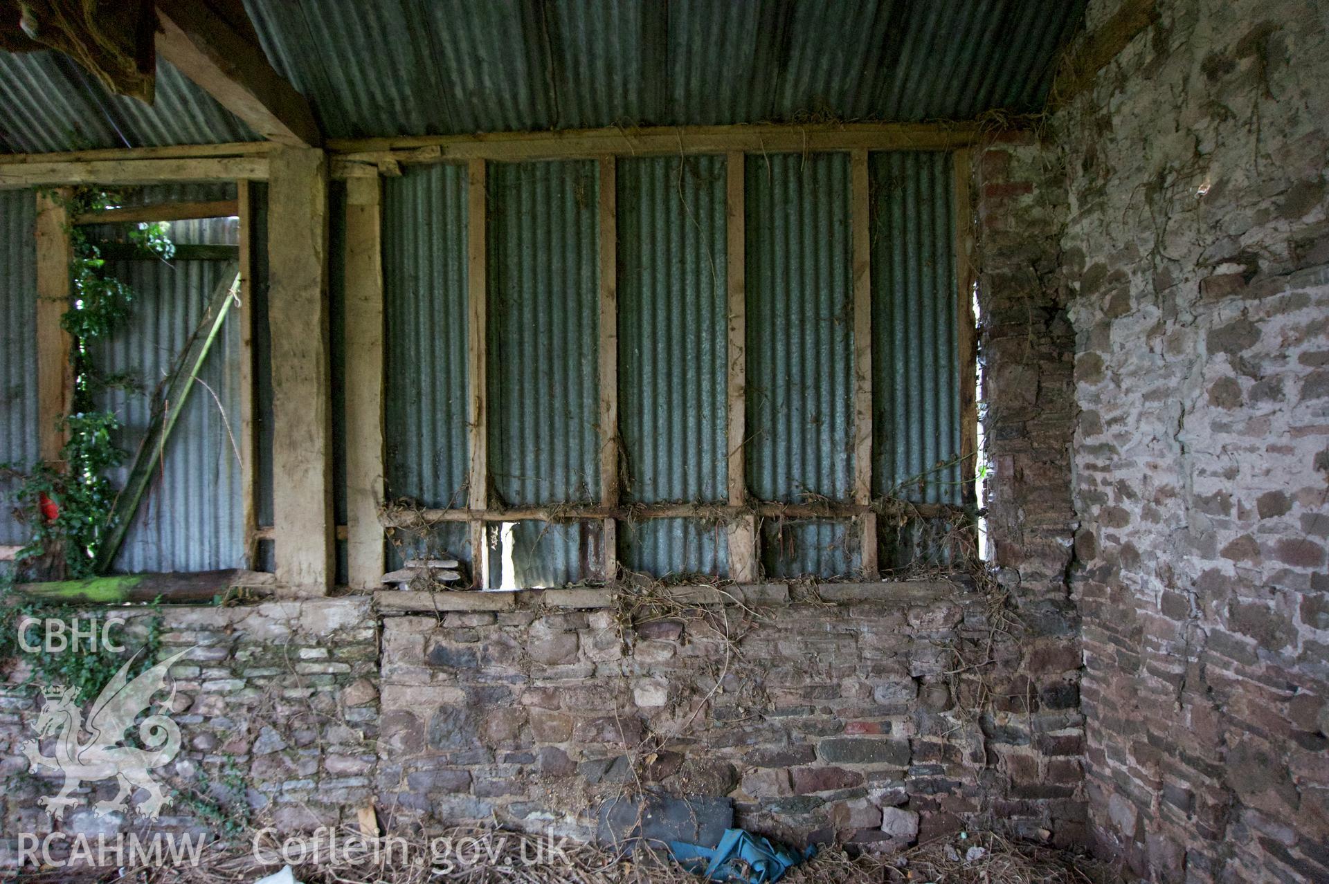 Internal view of the west end of the south wall at Middle Ton Threshing Barn. Photographed for the Historic Building Photographic Record of Middle Ton Threshing Barn, Llanvapley, by Dan Courtney of Cog Architects, 2019.