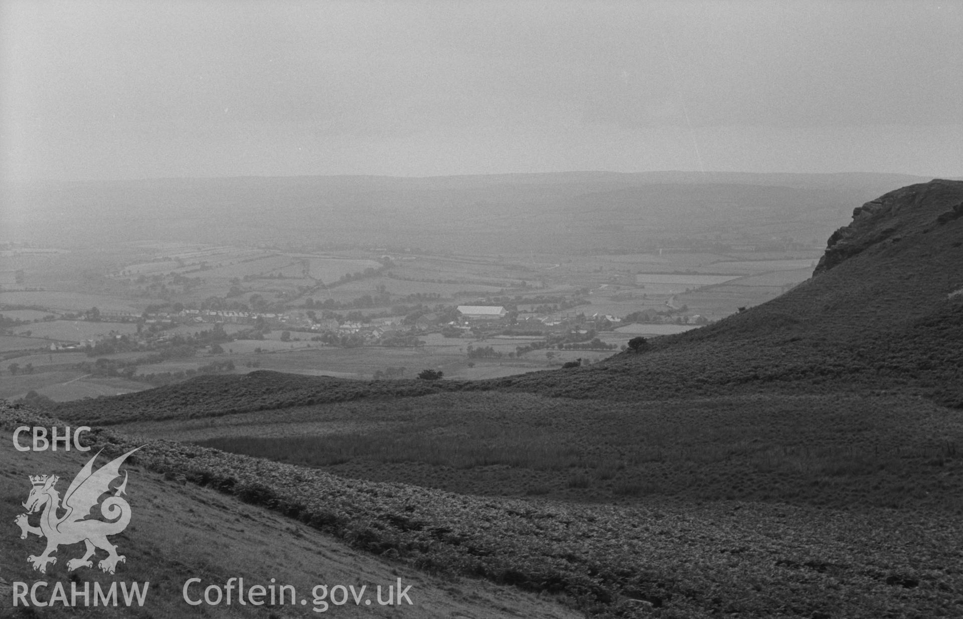 Digital copy of a black and white negative showing the village of Pontrhydfendigaid. Photographed by Arthur O. Chater on 25th August 1967 looking west from Banc Gwyn, south east of Pen y Bannau, at Grid Reference SN 743 667.