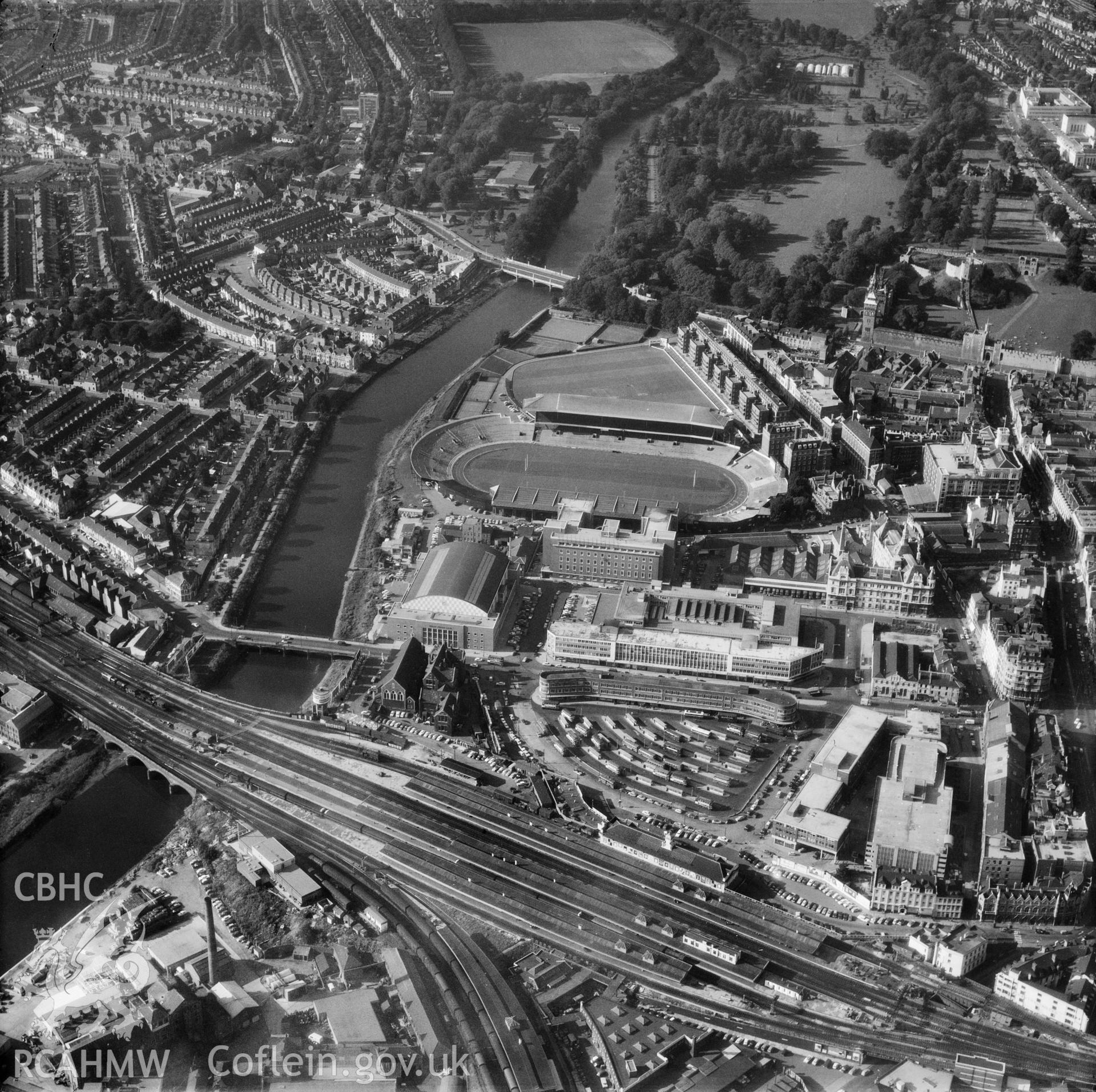 Digital copy of a black and white oblique aerial photograph showing view of the Empire Pool, Cardiff Arms Park and Cardiff Central Station, taken by Aerofilms Ltd, 1959.