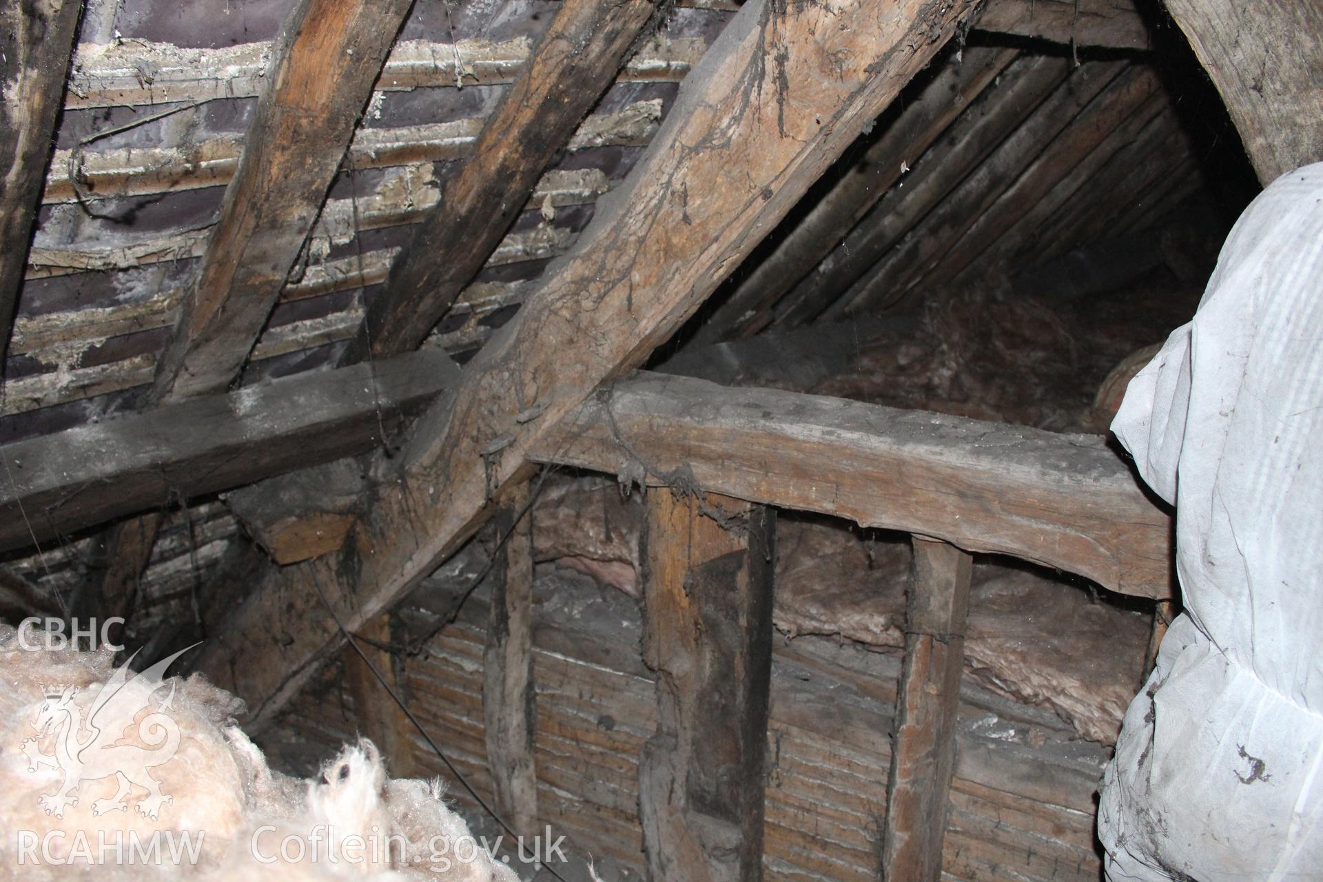 Colour photograph showing detail of timber frame and interior of roof in attic at 5 to 7 Mwrog Street, Ruthin. Photographed during survey conducted by Geoff Ward on 30th May 2014.