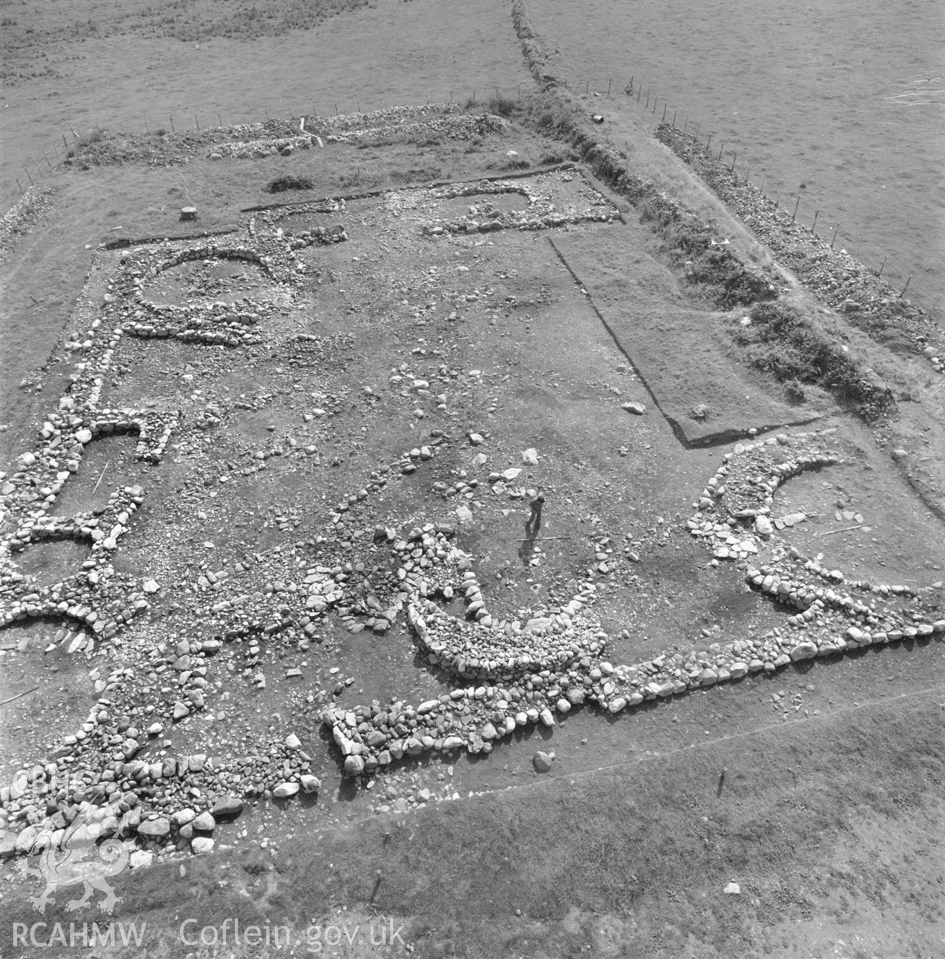 Digitised copy of a low level aerial shot of excavations at Enclosed Hut Group site SW of Cefn Graenog taken by RCAHMW, c1971.