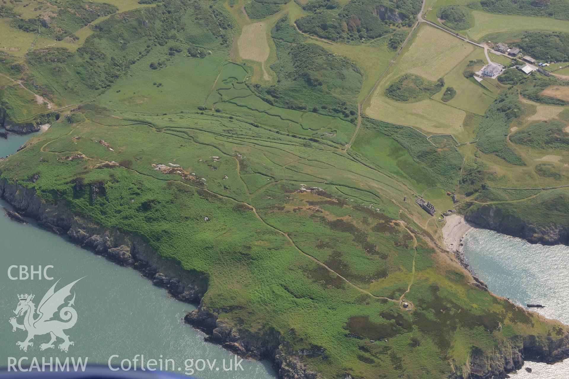 Dinas Gynfor hillfort, between Cemmaes and Amlwch on the north Anglesey coast.  Oblique aerial photograph taken during the Royal Commission?s programme of archaeological aerial reconnaissance by Toby Driver on 12th July 2013.
