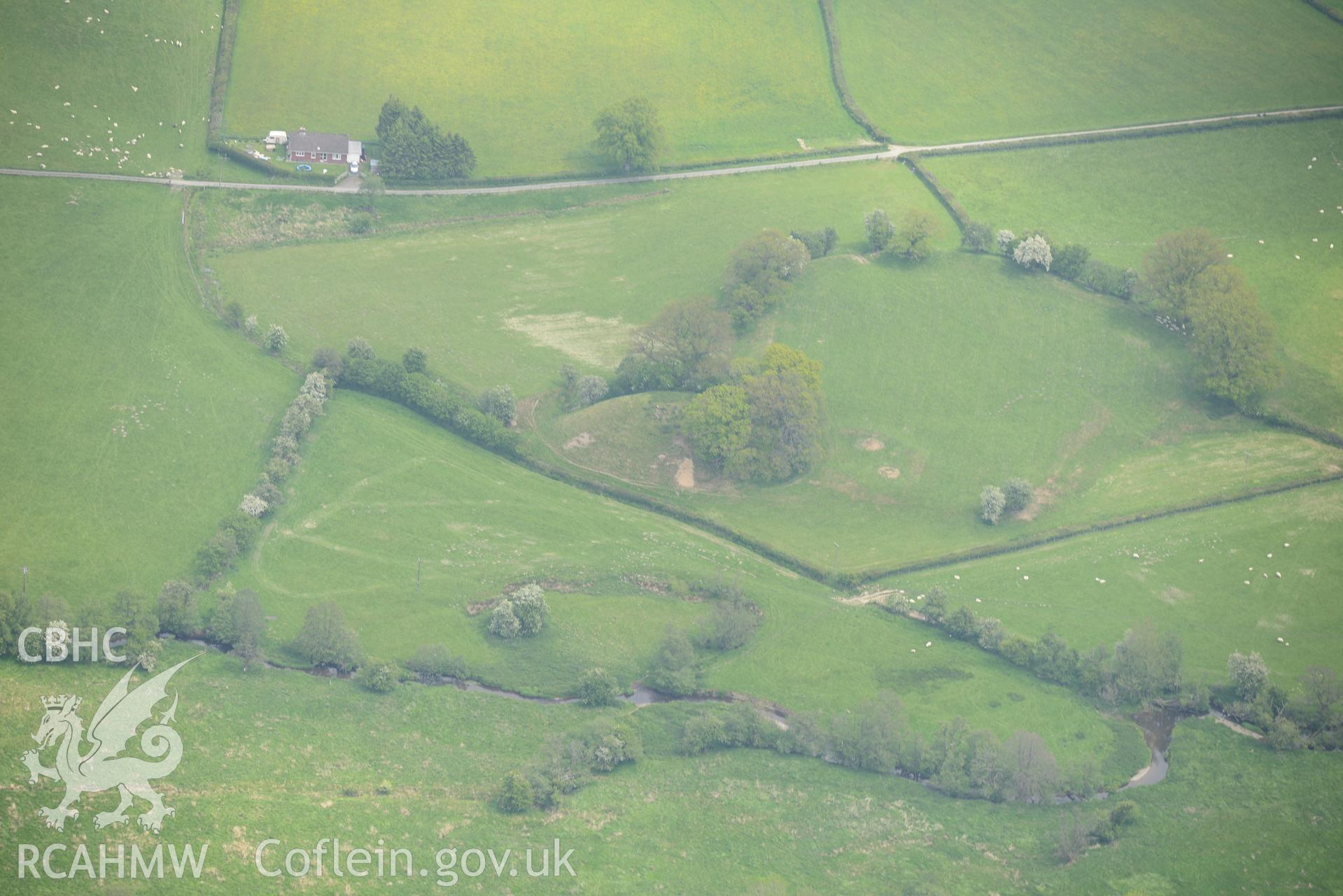 The Mount Motte and Bailey at Hundred House, near Builth Wells. Oblique aerial photograph taken during the Royal Commission's programme of archaeological aerial reconnaissance by Toby Driver on 11th June 2015.