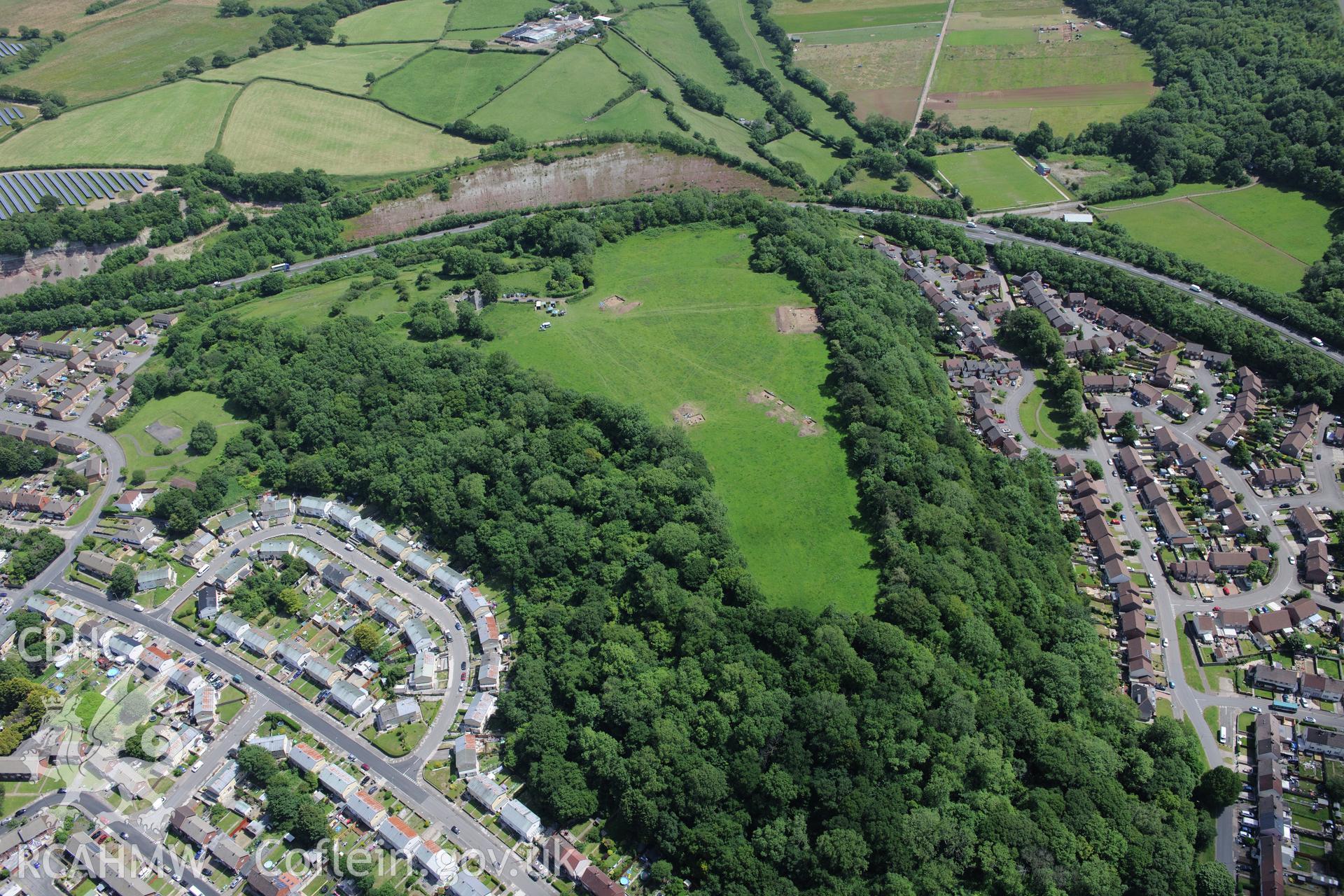 Caerau village and the excavation of Caerau Hillfort, Ely, conducted by Cardiff University. Oblique aerial photograph taken during the Royal Commission's programme of archaeological aerial reconnaissance by Toby Driver on 29th June 2015.