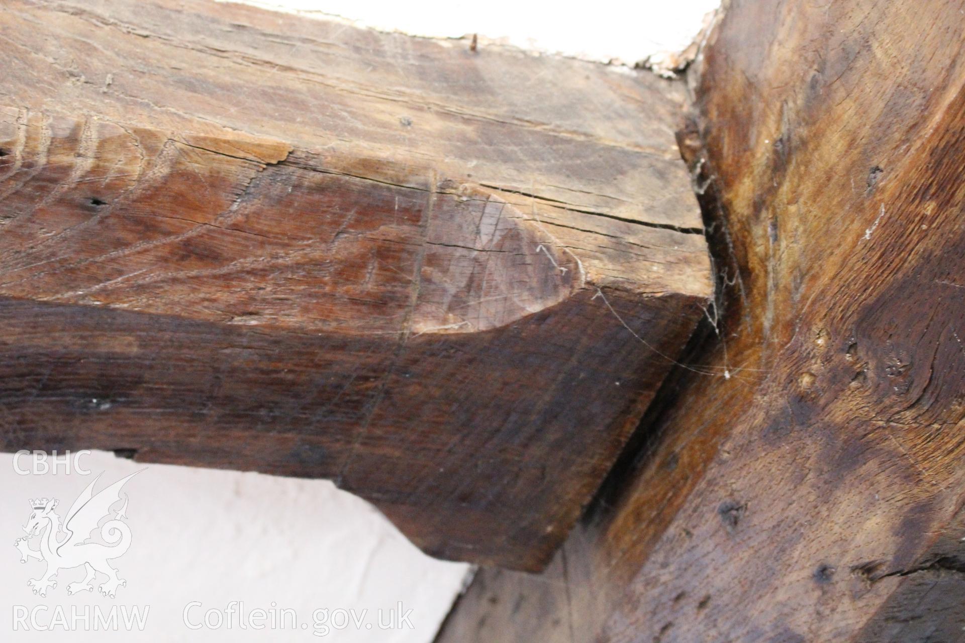 Colour photograph showing detail of wooden ceiling beam joint at 5-7 Mwrog Street, Ruthin. Photographed during survey conducted by Geoff Ward on 14th May 2014.