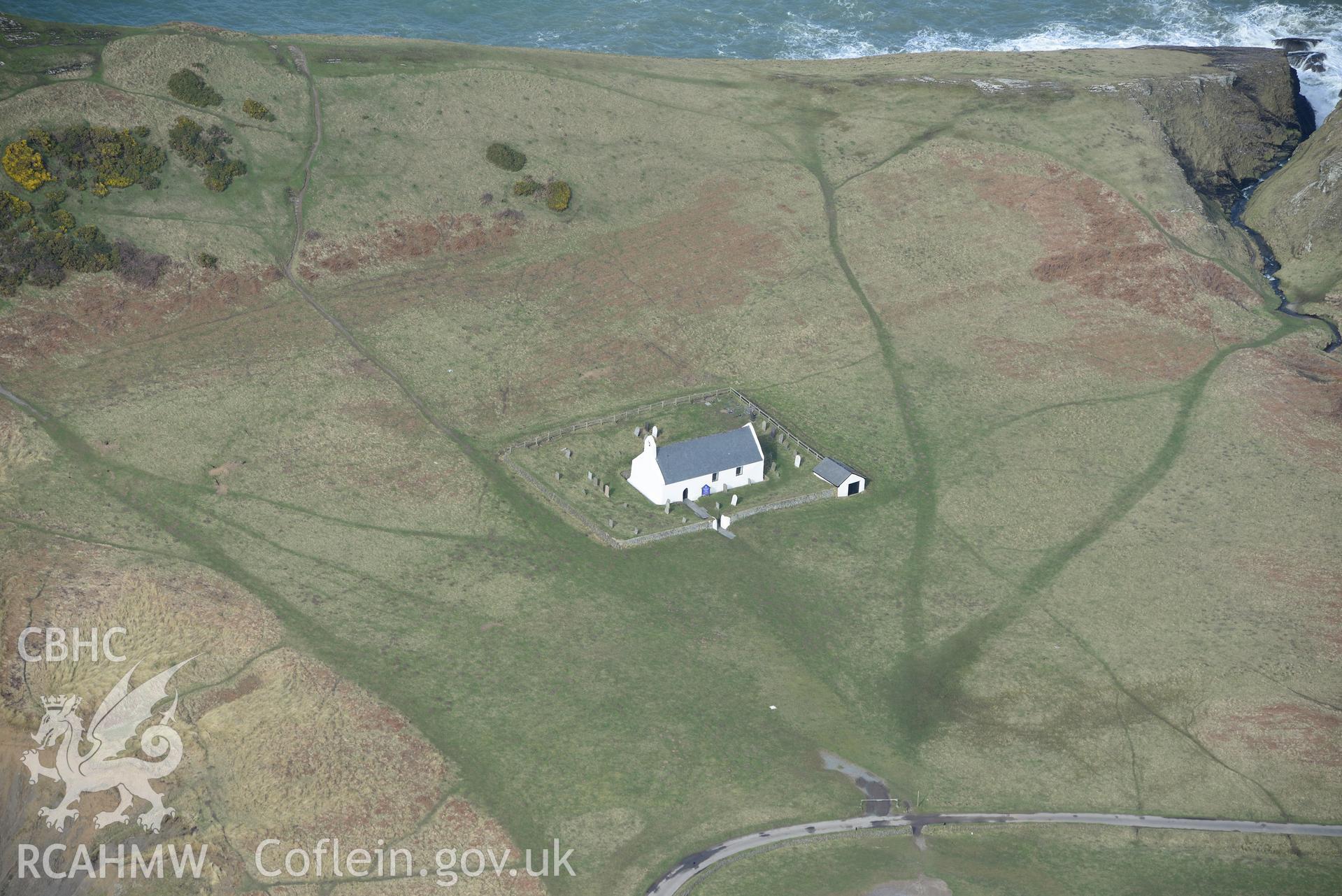 Holy Cross church, Mwnt. Oblique aerial photograph taken during the Royal Commission's programme of archaeological aerial reconnaissance by Toby Driver on 13th March 2015.