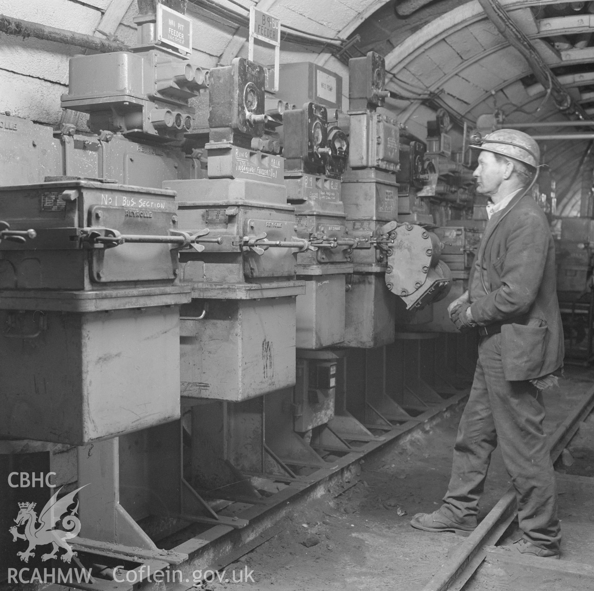 Digital copy of an acetate negative showing electrician and transformers in a sub station for a district at Taff Colliery, from the John Cornwell Collection.