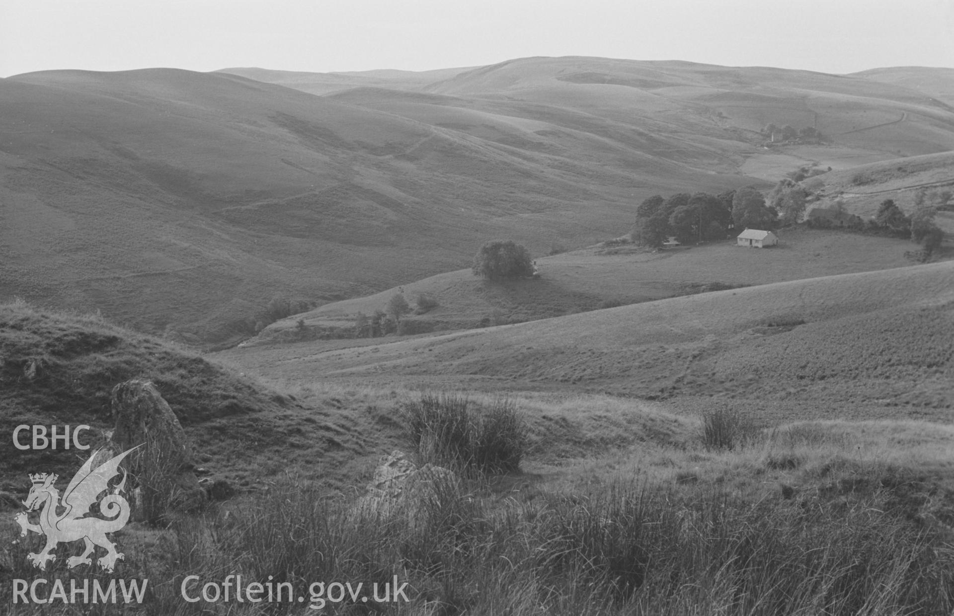 Digital copy of black & white negative showing view looking up the valley of Pysgotwr Fawr; Bryn-Ambor farm and lead mine in middle distance; Bryn-Glas in far distance on right. Photograph by Arthur O. Chater, September 1966, looking west from SN 749 507.
