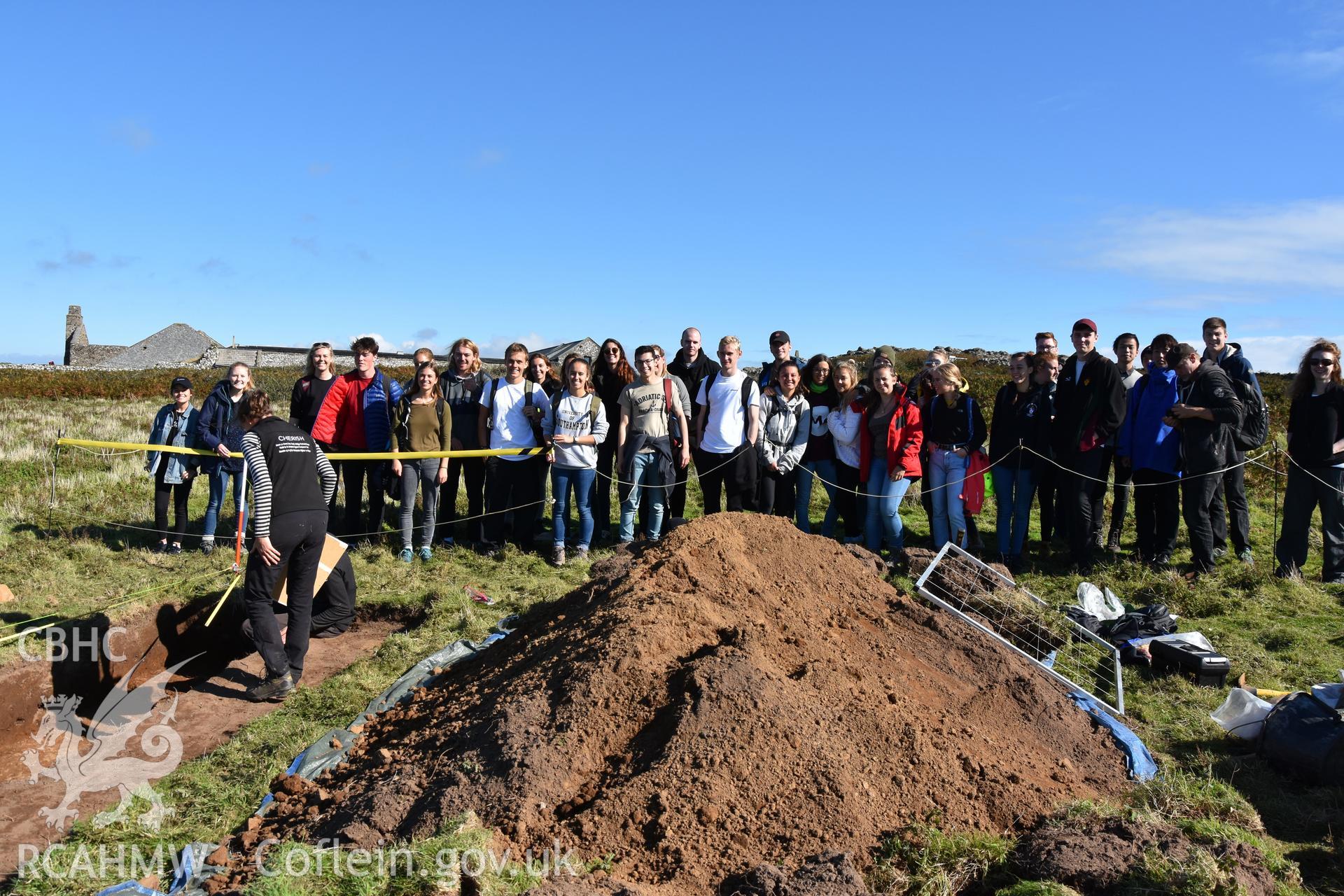 Investigator's photography showing the evaluation excavation of a geophysical anomaly in Well Meadow, Skomer Island, between 25-27th Sept 2018 as part of the Skomer Island Project. Visit to trench by students from Southampton University.