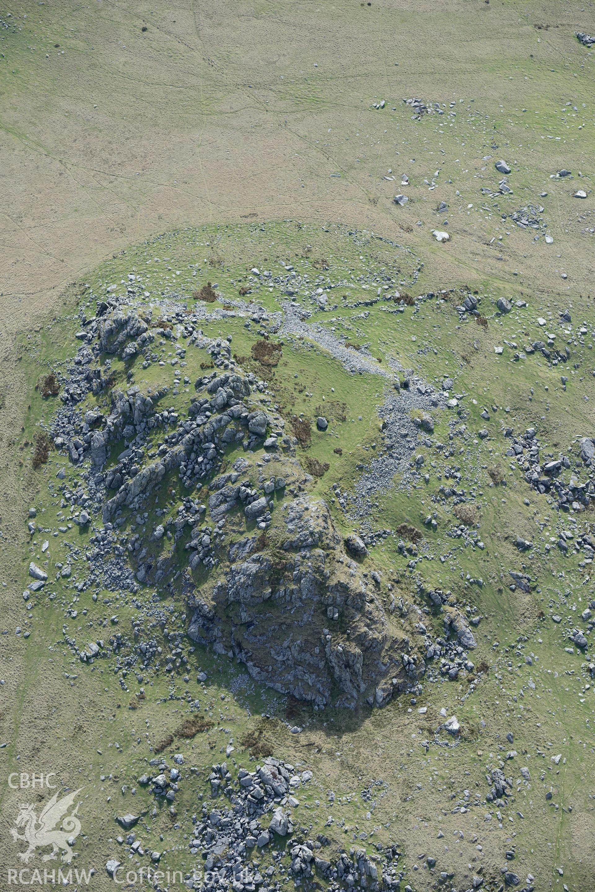 Carn Alw Hillfort. Oblique aerial photograph taken during the Royal Commission's programme of archaeological aerial reconnaissance by Toby Driver on 15th April 2015.'