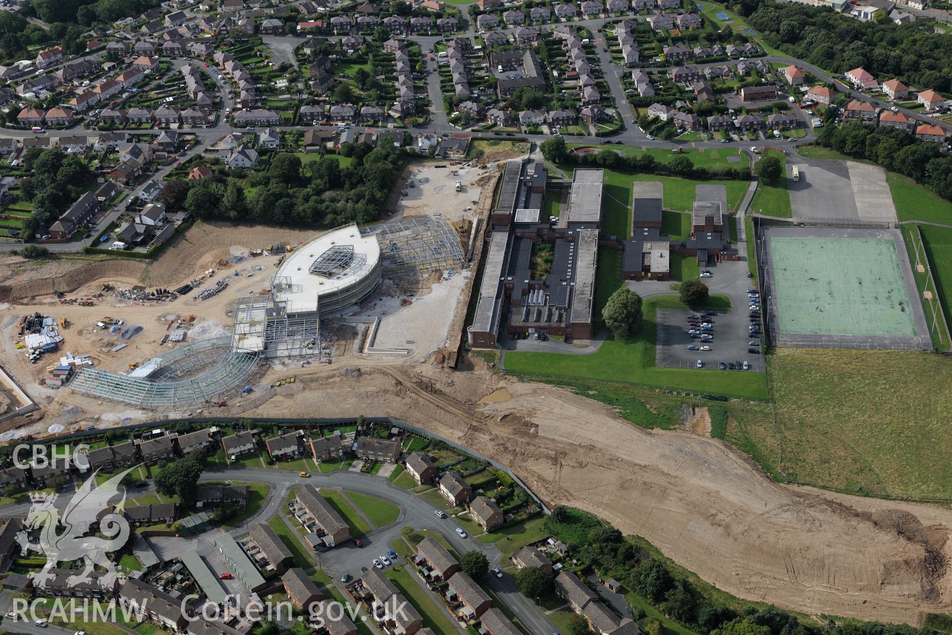 Holywell High School, with Ysgol Treffynon and Ysgol Maes y Felin under construction behind. Oblique aerial photograph taken during the Royal Commission's programme of archaeological aerial reconnaissance by Toby Driver on 11th September 2015.