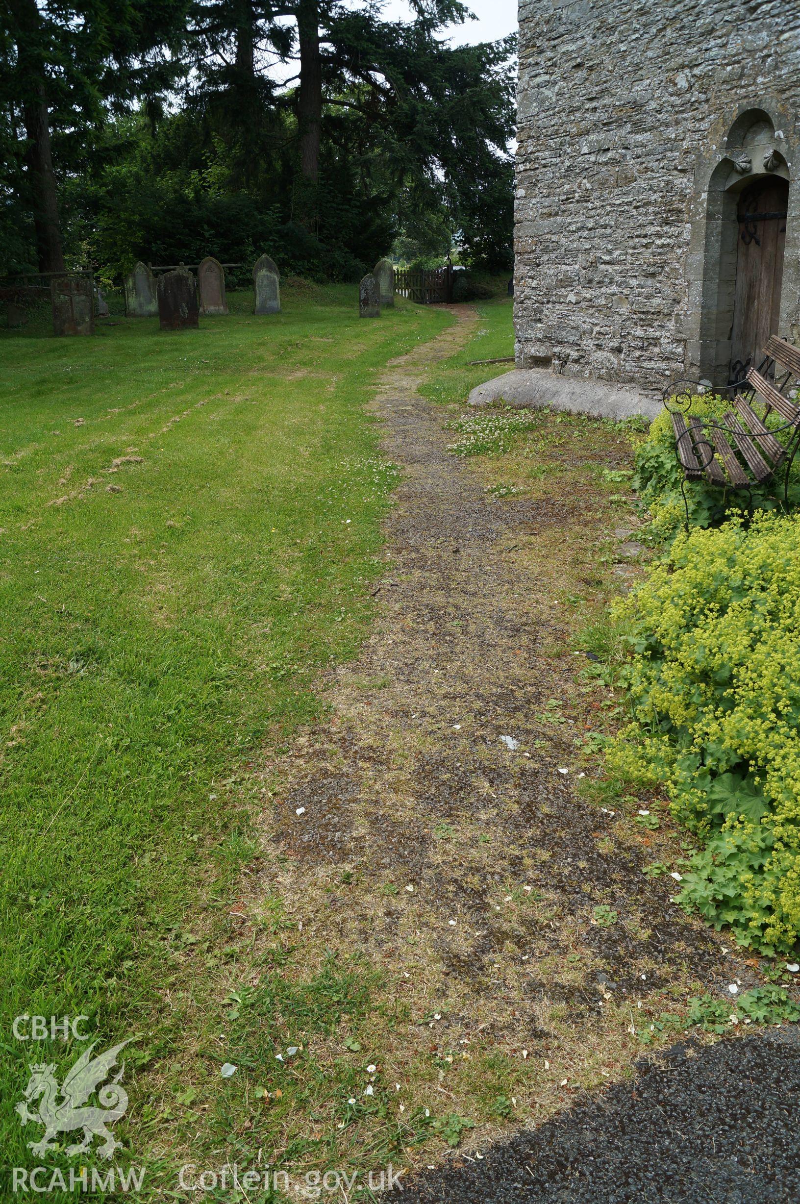 View 'looking west northwest at the pathway running west northwest from the porch of St. Mary's' in Gladestry, Powys. Photograph and description by Jenny Hall and Paul Sambrook of Trysor, 21st June 2017.