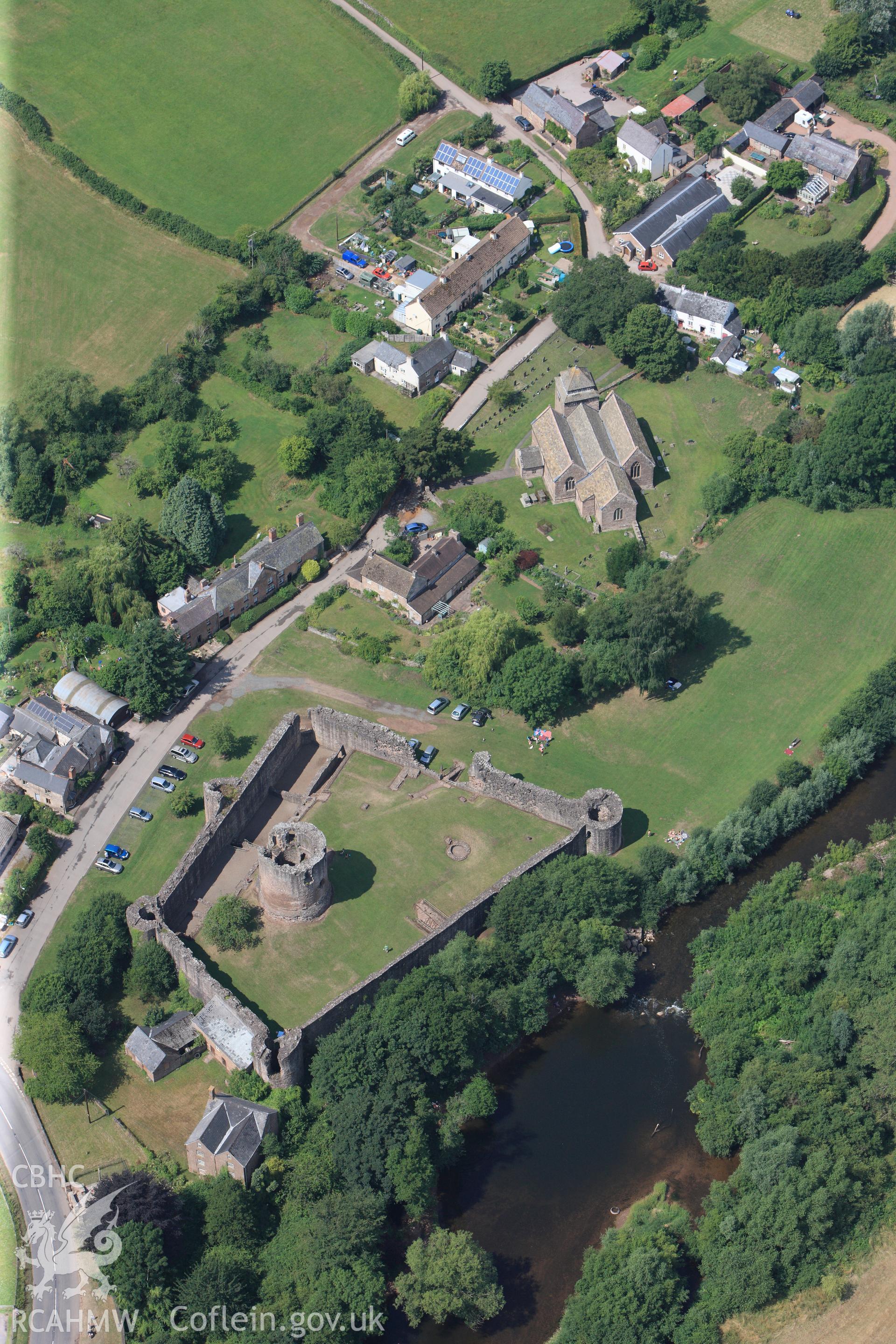 Skenfrith Castle, with Skenfrith corn mill immediately to the south east and St. Bridget's Church to the north west, Skenfrith, Monmouth. Oblique aerial photograph taken during Royal Commission?s programme of archaeological aerial reconnaissance by Toby Driver on 1st August 2013.