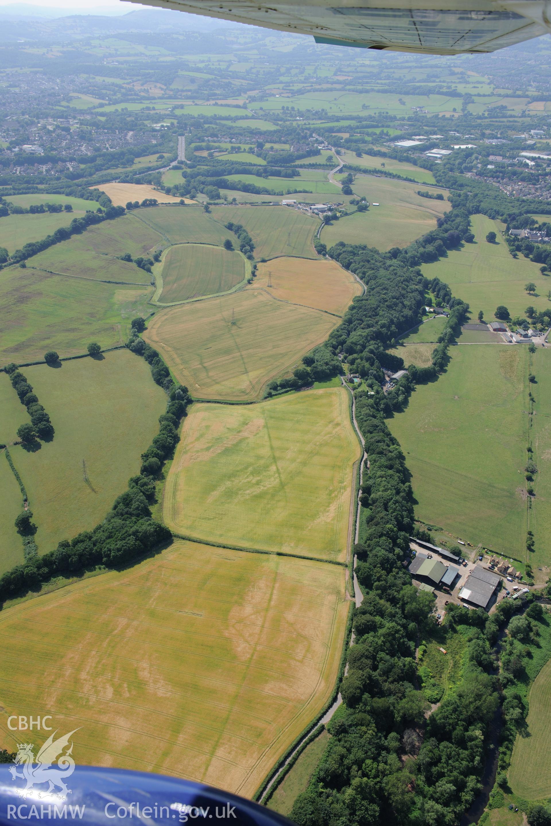 Malthouse Road defended enclosures, linear ditch, and Graig-yr-Eurych castle mound, north west of Caerleon. Oblique aerial photograph taken during the Royal Commission?s programme of archaeological aerial reconnaissance by Toby Driver on 1st August 2013.