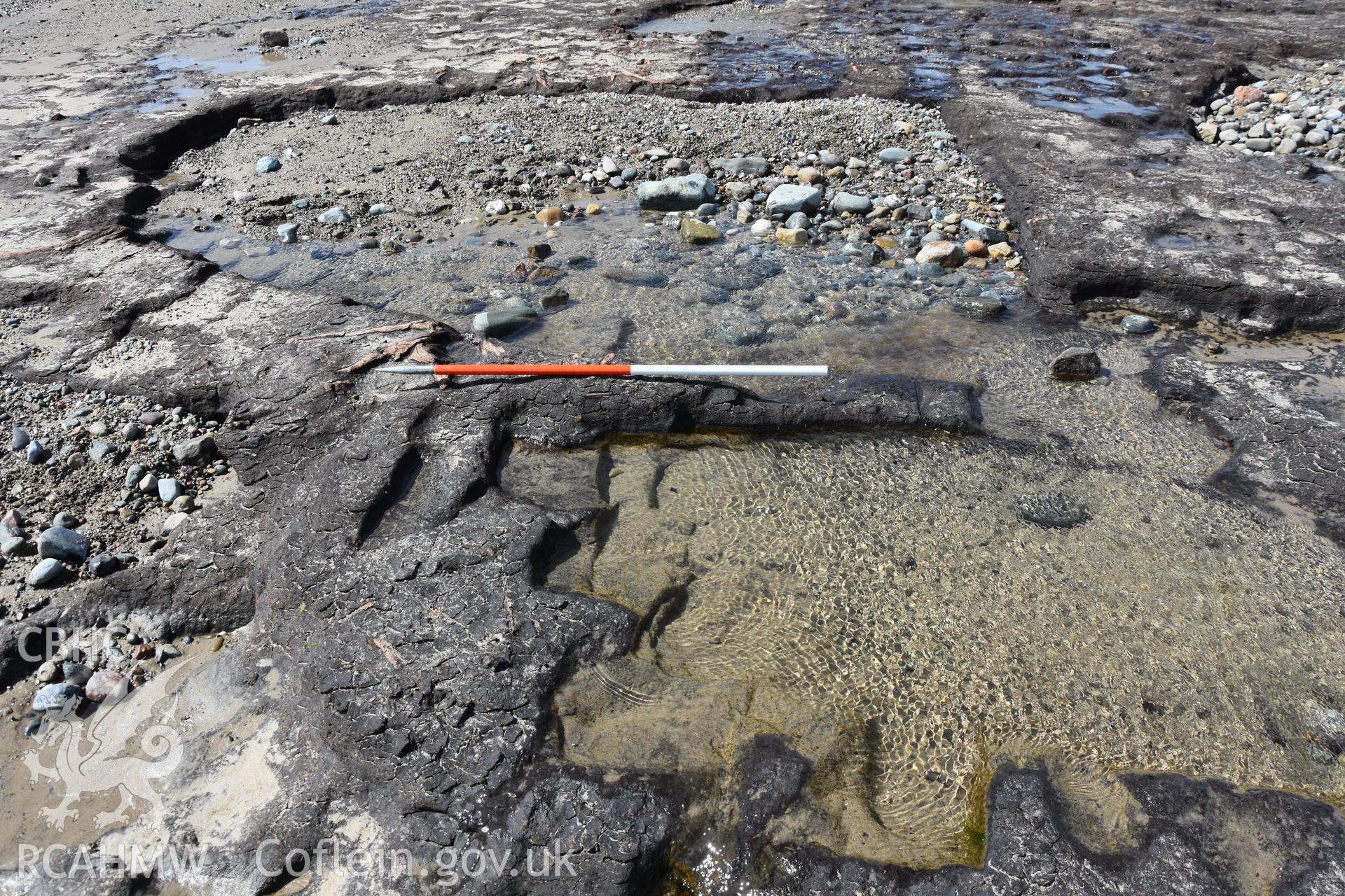 Photography of medieval or post-medieval peat cuttings preserved in the eastern part of the peats on The Warren beach, Abersoch. Recorded with GNSS and photogrammetry for the CHERISH Project. ? Crown: CHERISH PROJECT 2018. Produced with EU funds through the Ireland Wales Co-operation Programme 2014-2020. All material made freely available through the Open Government Licence.