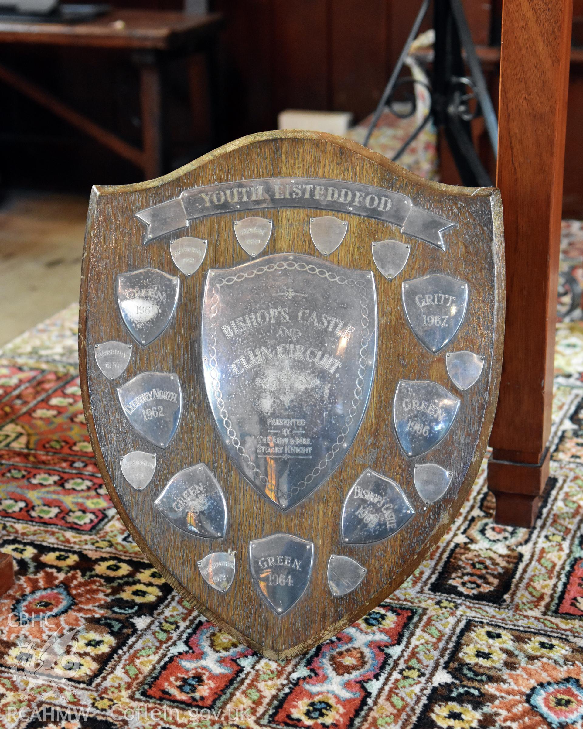 Wooden shield-shaped trophy at Hyssington Chapel for the Bishops Castle and Clun Circuit Youth Eisteddfod, presented by The Revd. & Mrs Stuart Knight. Photographic survey conducted by Sue Fielding on 7th December 2018.