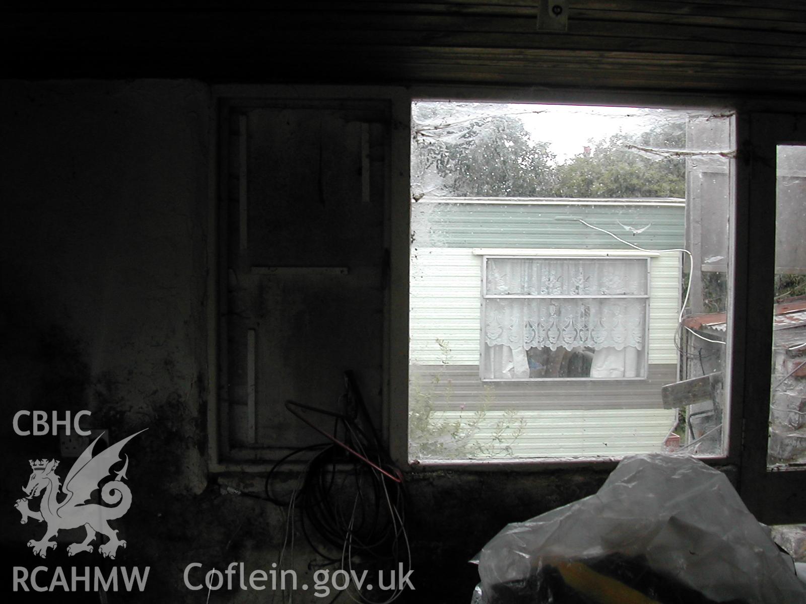Colour photograph showing detailed interior view of window looking at caravan at Rosacre, Gronant, Prestatyn. Unknown date. Donated by the Conservation Department of Flintshire County Council, in advance of relocation to new offices.