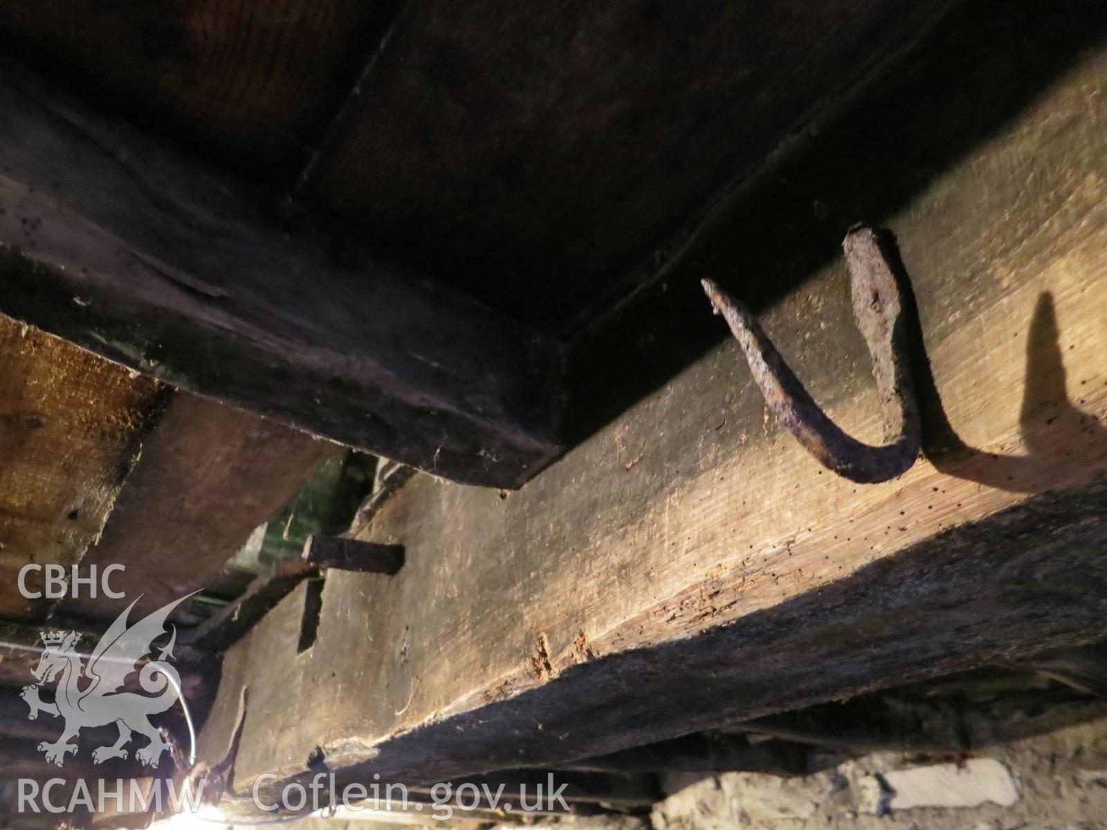 Interior ceiling beam and hooks of barn at Pencerrig Pellaf, Ffordd Uchaf, Harlech. Photographed by Kimberley Urch as part of photographic survey for planning application (ref. no. NP5/61/LB446A Snowdonia National Park Authority).