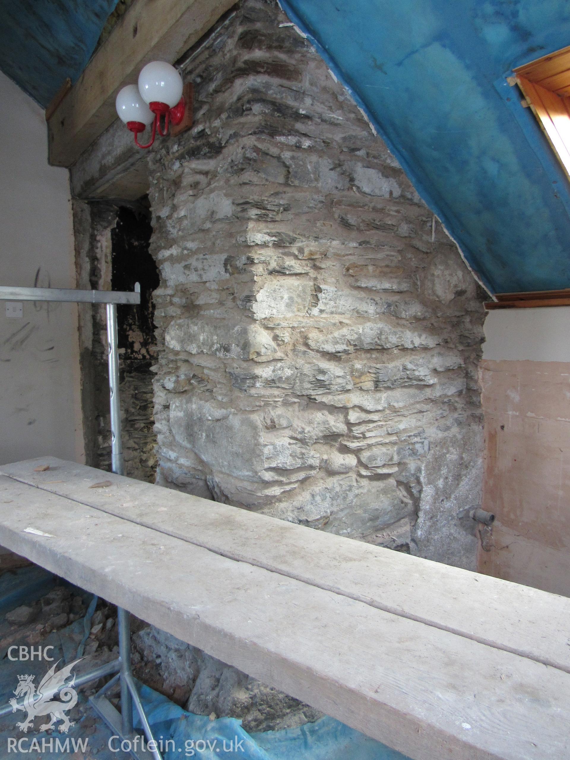 Original western corner of the house, now incorporated into the modern extension, view east. Photographed for archaeological building recording conducted at Bryn Ysguboriau, Llanelidan, Denbighshire, carried out by Archaeology Wales, 2018.