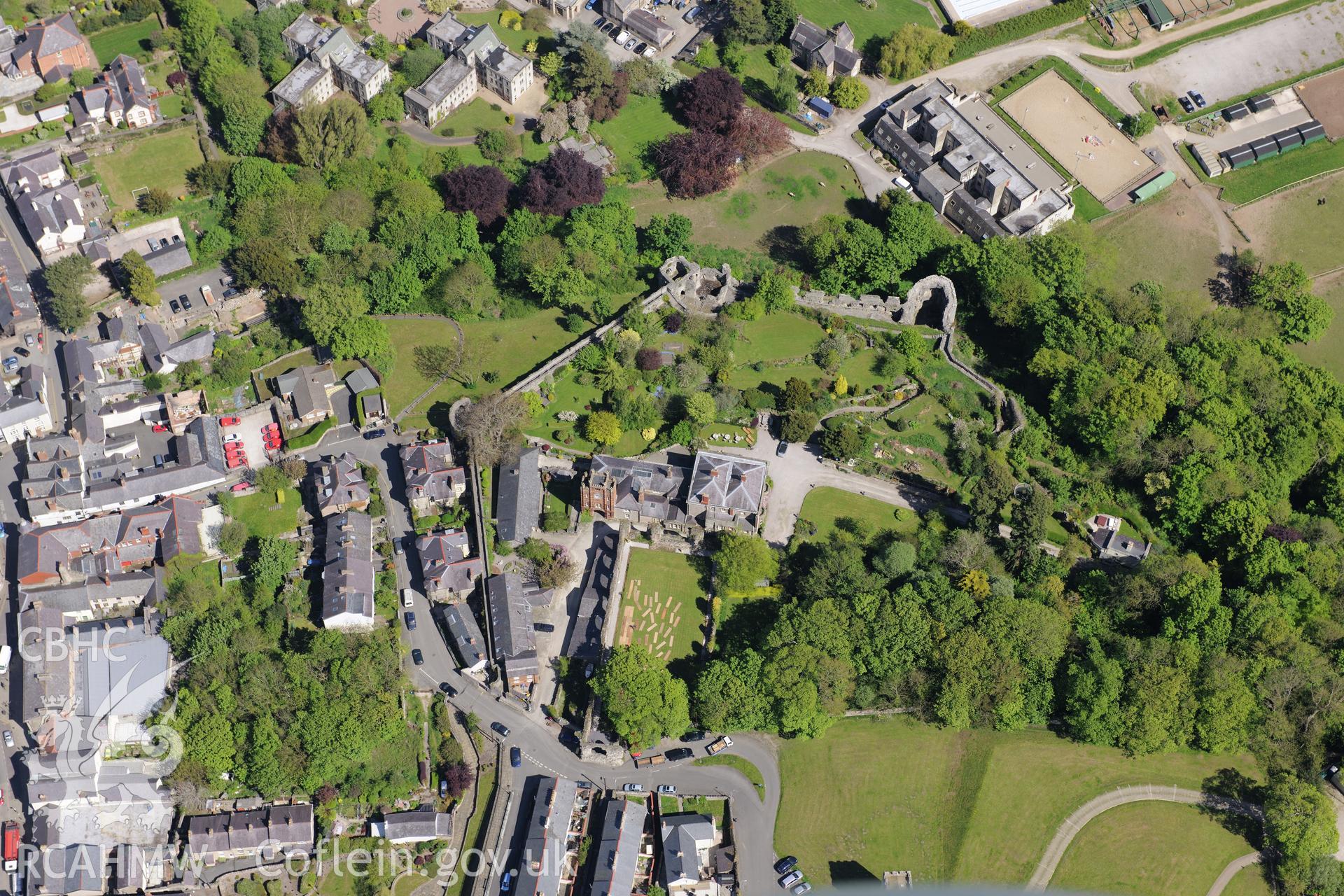 Denbigh town wall, Goblin Tower, St. David's church, Castle House and Howell's School, Denbigh. Oblique aerial photograph taken during the Royal Commission?s programme of archaeological aerial reconnaissance by Toby Driver on 22nd May 2013.